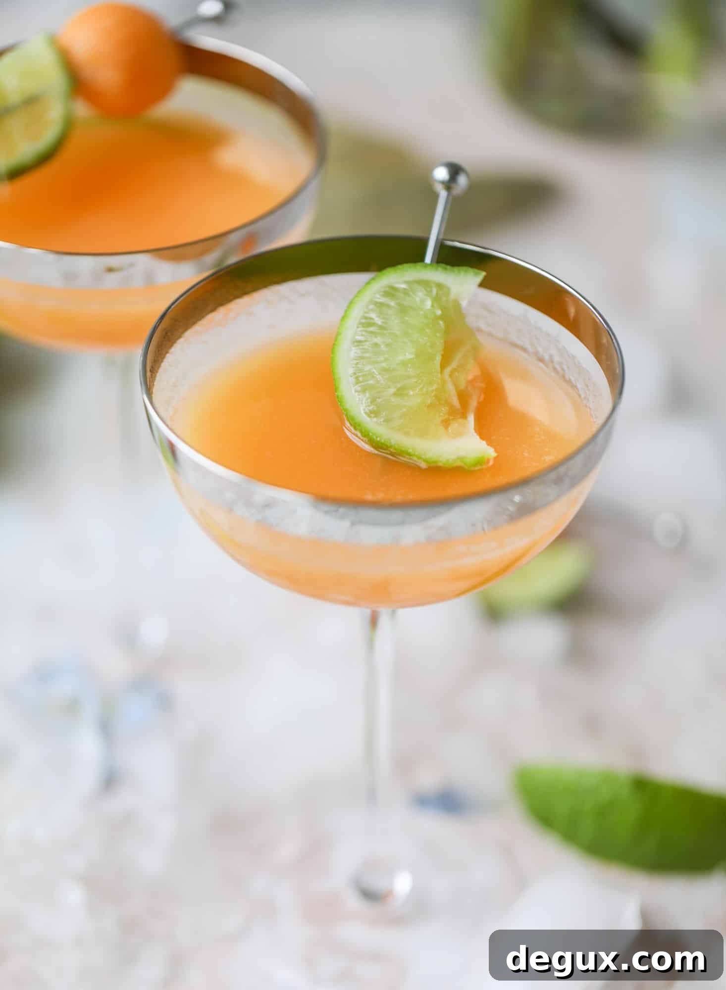 Cantaloupe Daiquiri Recipe: Fresh, Tropical Summer Cocktail 11 This cantaloupe daiquiri is the perfect way to celebrate summer! Freshly juiced melon, lime juice, rum and maraschino cherries - it's refreshing and cool and a fantastic cocktail to have during happy hour! Isn't the color amazing too?!