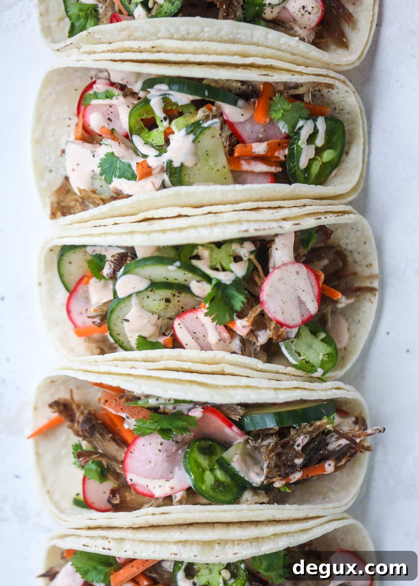 Banh Mi Tacos: Vietnamese Sandwich Flavors in Soft Tortillas 11 These bahn mi tacos are the perfect twist on the classic sandwich! Juicy pulled pork, pickled veggies, a tangy crema and loads of flavor. Bahn mi tacos are a delish weeknight meal or also work great if you have pork leftovers! I howsweeteats.com #bahn #mi #tacos #pork #dinner