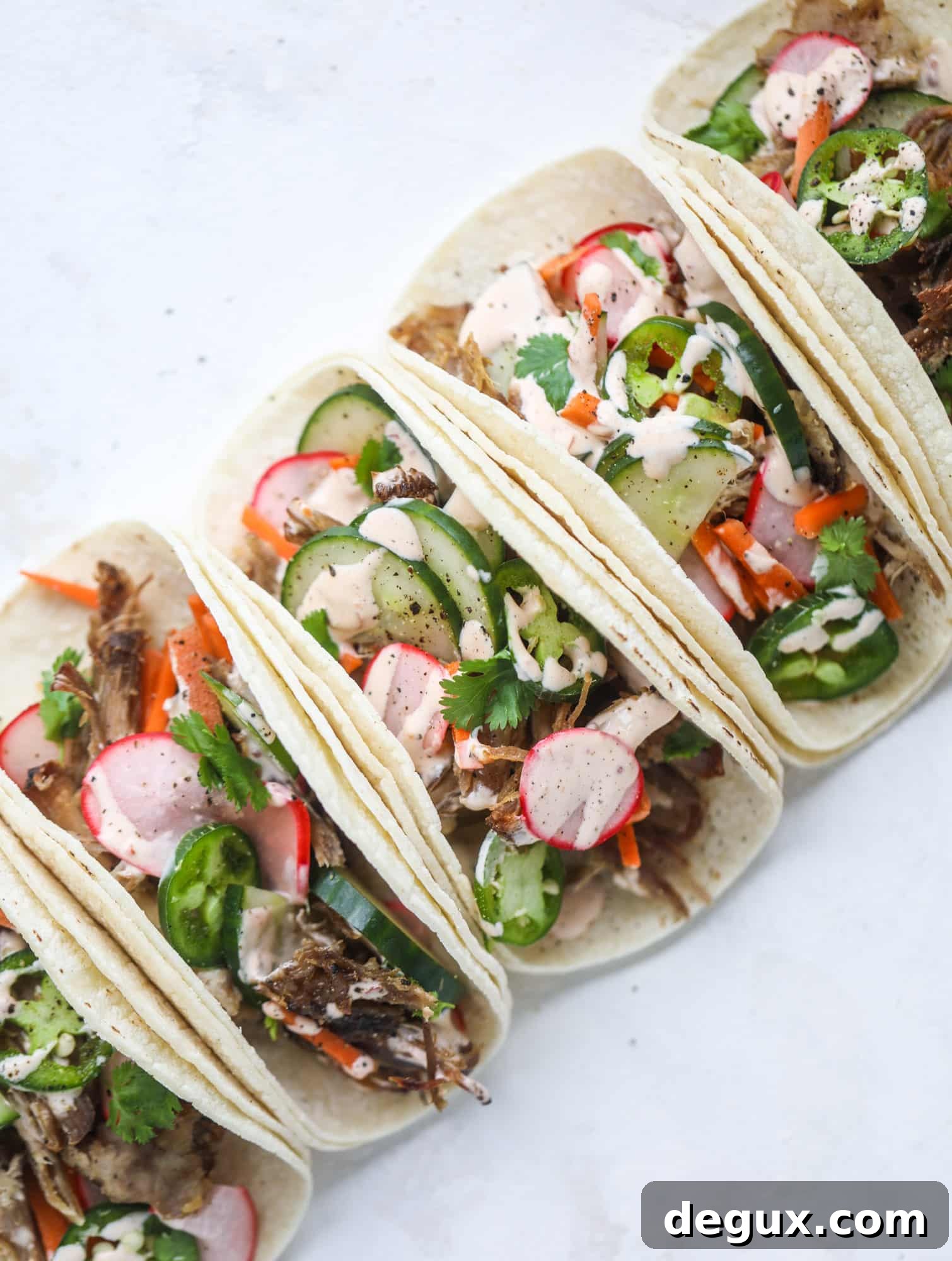 Banh Mi Tacos: Vietnamese Sandwich Flavors in Soft Tortillas 9 These bahn mi tacos are the perfect twist on the classic sandwich! Juicy pulled pork, pickled veggies, a tangy crema and loads of flavor. Bahn mi tacos are a delish weeknight meal or also work great if you have pork leftovers! I howsweeteats.com #bahn #mi #tacos #pork #dinner