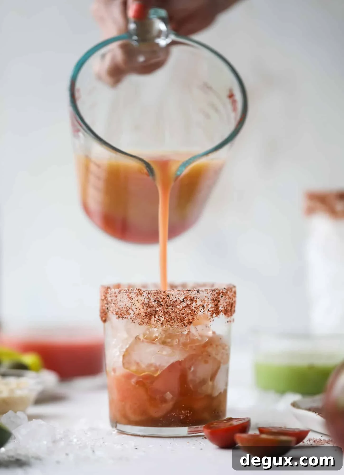 Heirloom Tomato Bloody Mary Recipe with Fresh Garden Flavor 4 This bloody mary recipe is made with fresh heirloom tomatoes - the gems of summer! The colors swirl together to create a stunning drinking that is loaded with smoky, spicy flavor. Top with your favorite snacks foe the perfect brunch! I howsweeteats.com #bloody #mary #recipe #best #heirloom #tomatoes #cocktail