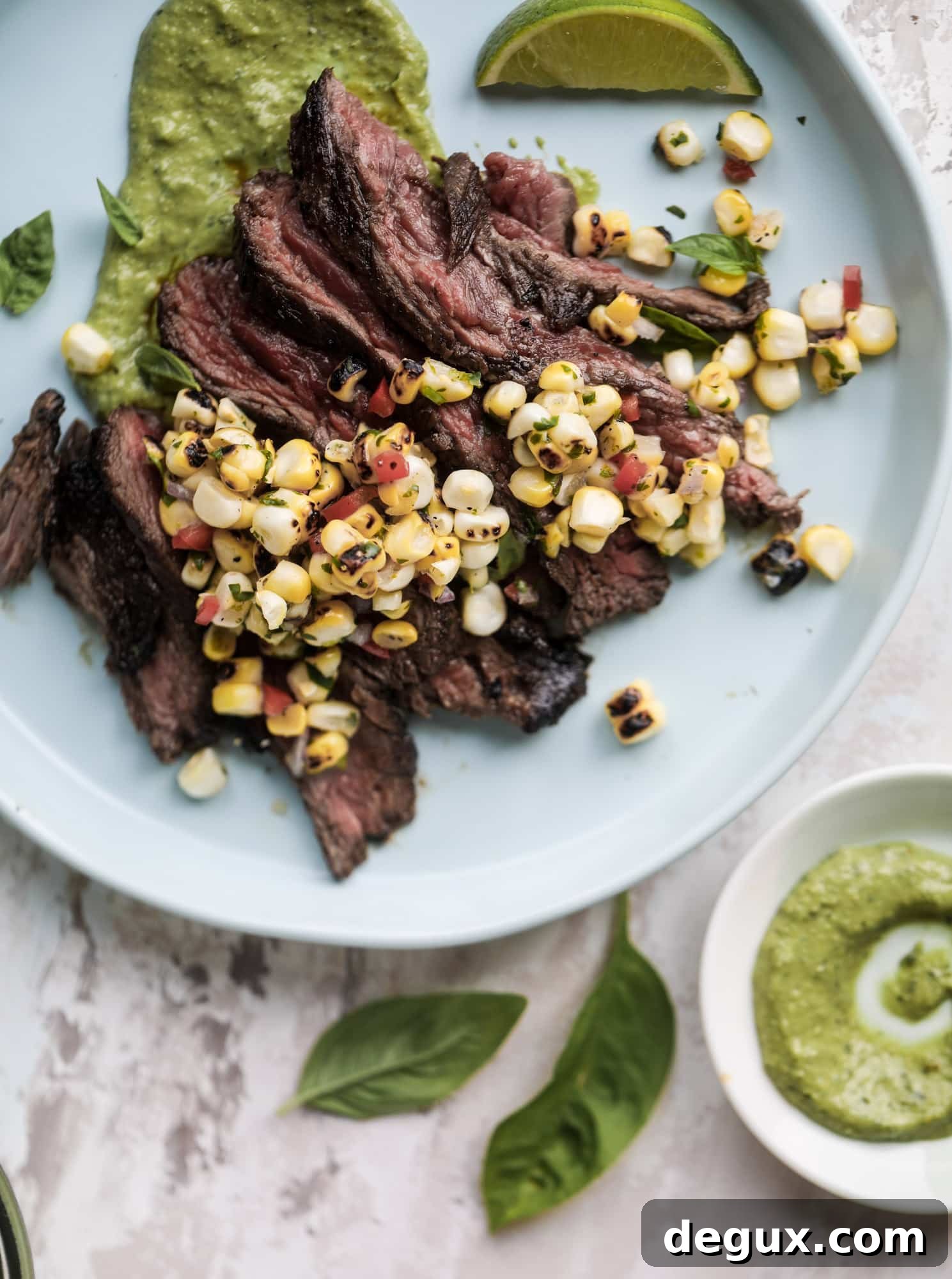 This skirt steak recipe is so super easy and delicious! Marinate it for a bit, prepare it to your liking then serve it with the most flavorful avocado pesto and grilled corn relish. Feels like a fancy restaurant meal and will make you love skirt steak forever! I howsweeteats.com #skirt #steak #avocado #pesto #corn #relish #recipes