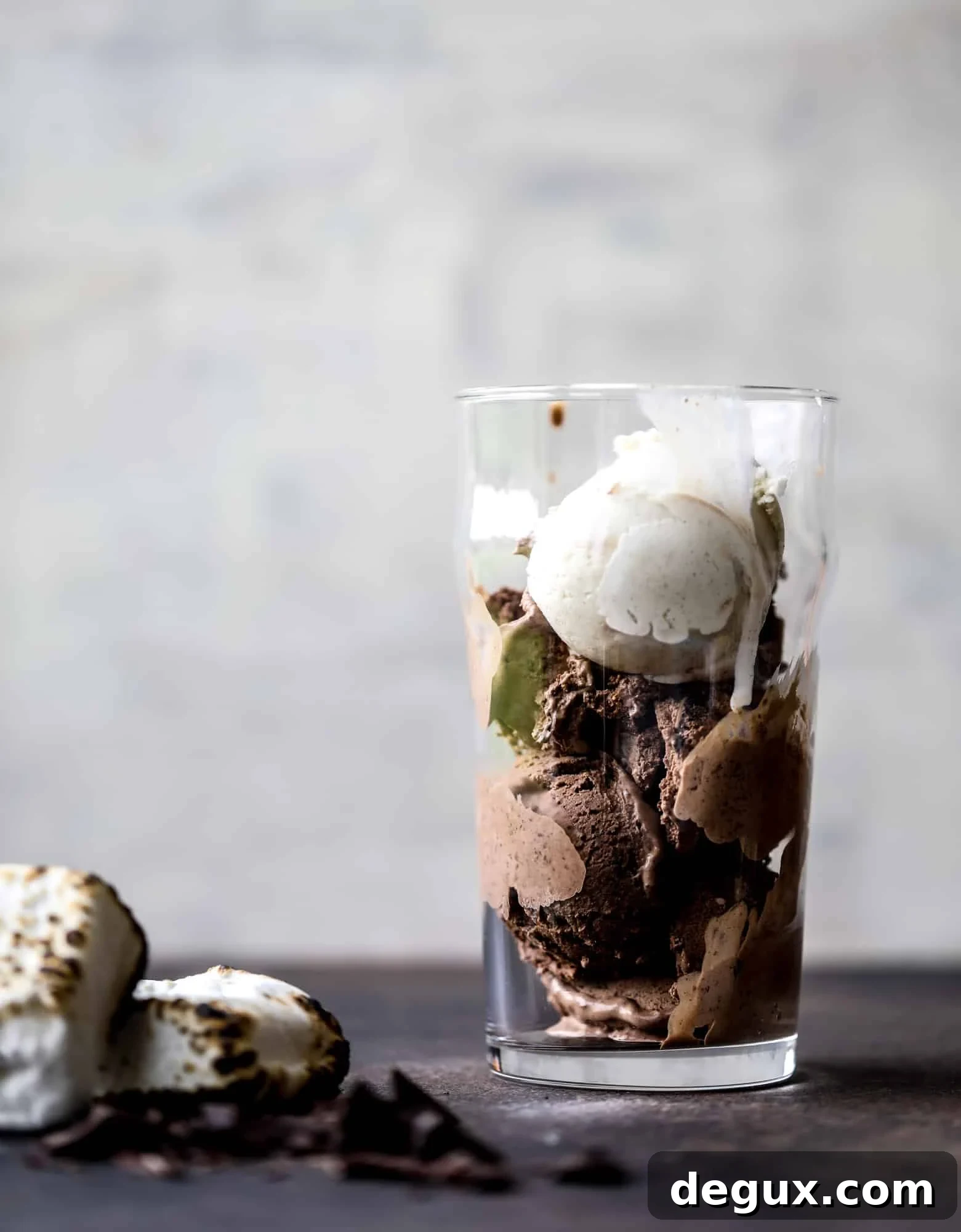 This is the most perfect root beer float, complete with both chocolate and vanilla ice creams. Topped with a smoky s'more, a chocolate fudge rim and a sprinkle of graham cracker crumbs take this super fun drink over the top! I howsweeteats.com #root #beer #float #summer #s'mores #drinks