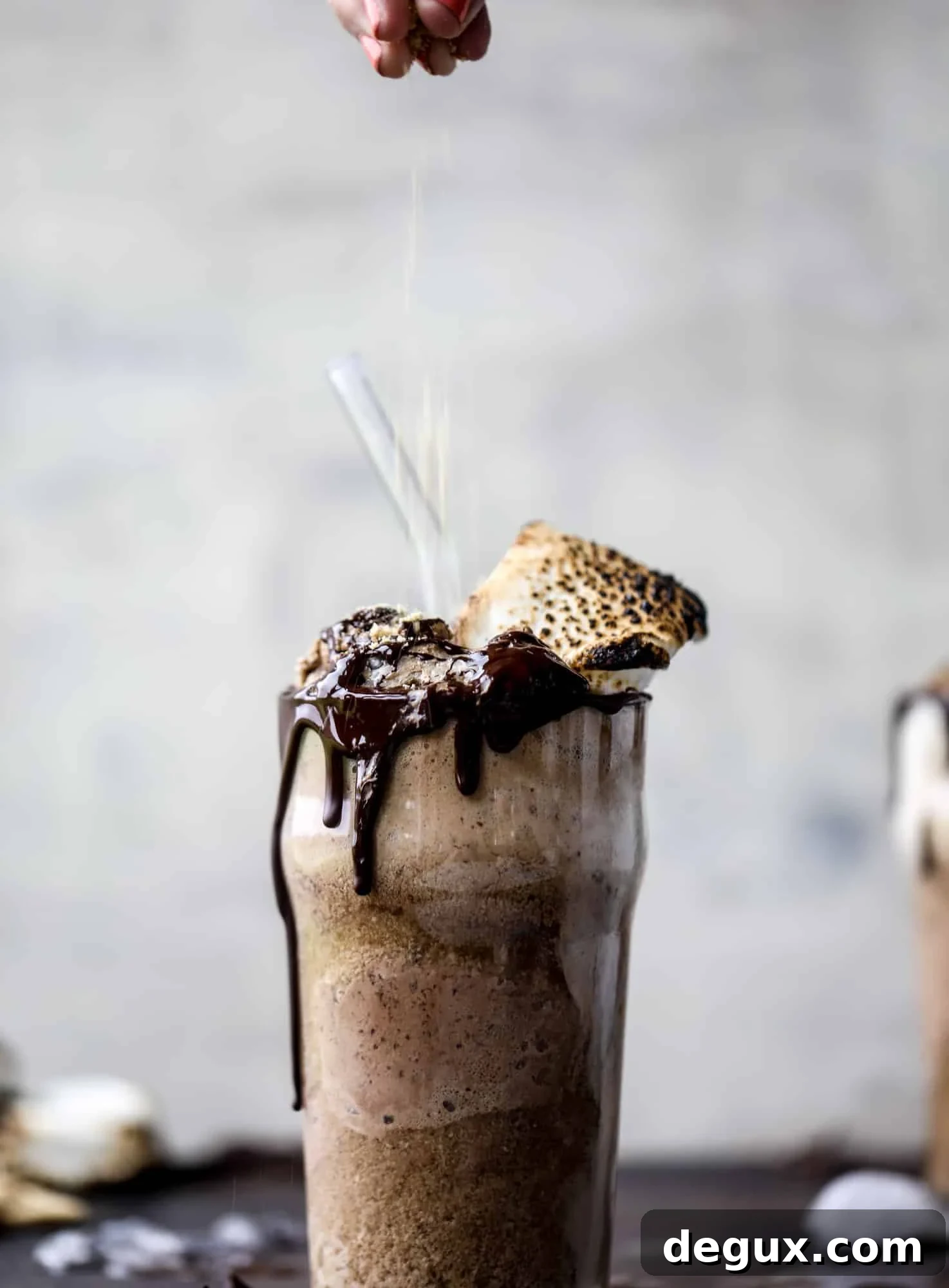 This is the most perfect root beer float, complete with both chocolate and vanilla ice creams. Topped with a smoky s'more, a chocolate fudge rim and a sprinkle of graham cracker crumbs take this super fun drink over the top! I howsweeteats.com #root #beer #float #summer #s'mores #drinks