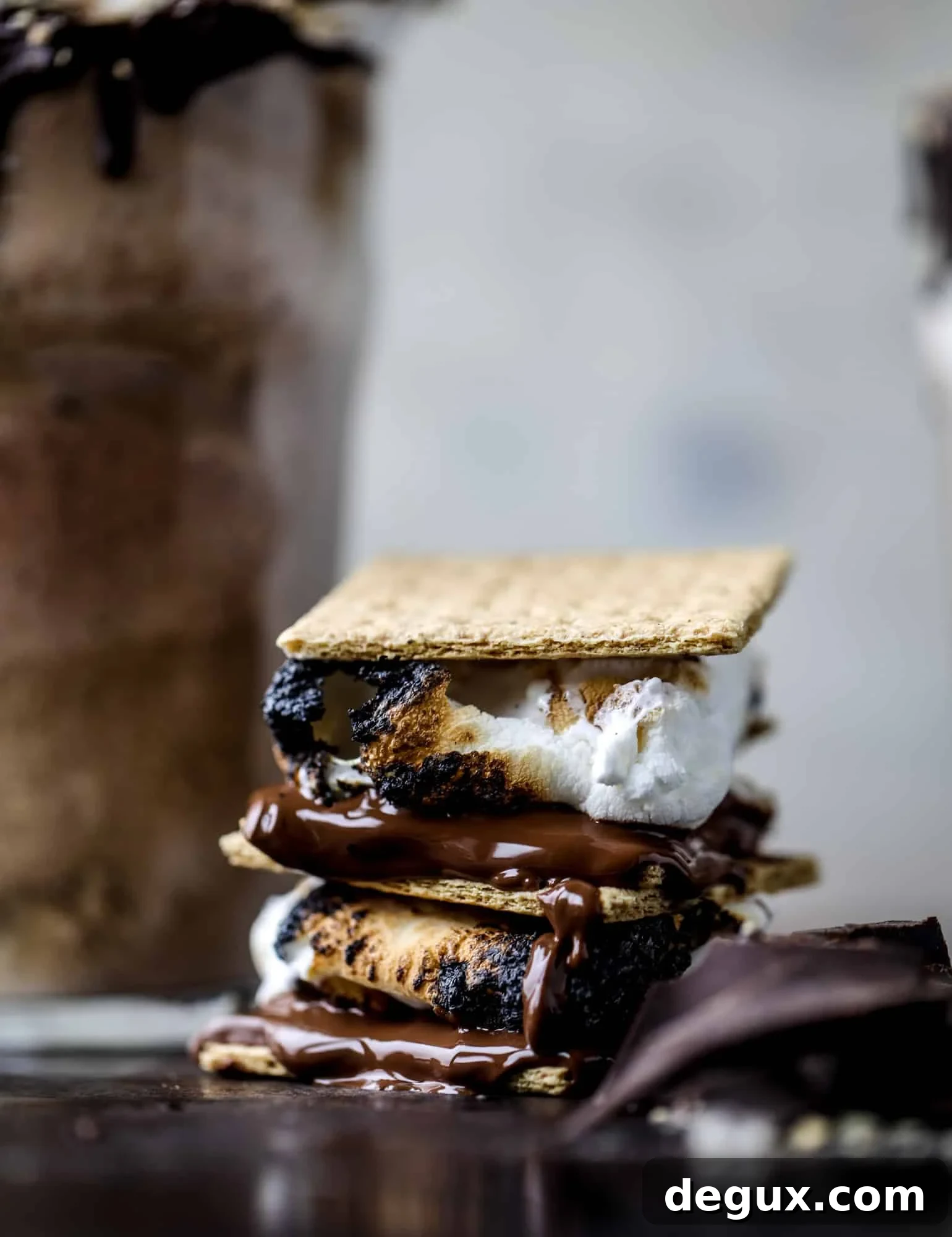This is the most perfect root beer float, complete with both chocolate and vanilla ice creams. Topped with a smoky s'more, a chocolate fudge rim and a sprinkle of graham cracker crumbs take this super fun drink over the top! I howsweeteats.com #root #beer #float #summer #s'mores #drinks