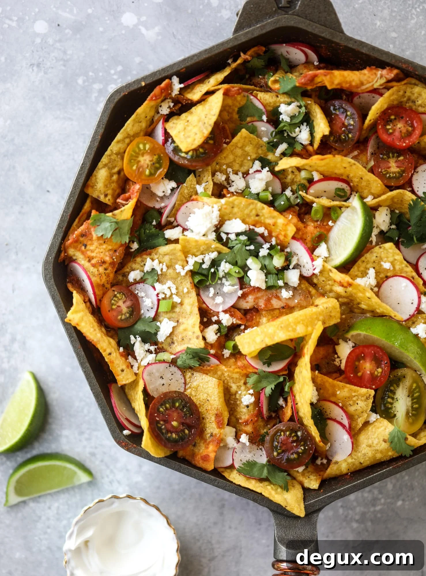 This skillet of fire roasted chicken chilaquiles is so easy, flavorful and delicious! A quick blender sauce made with fire roasted tomatoes, shredded chicken, lots of tortilla chips and your favorite toppings. Give me all the cheese and guacamole! I howsweeteats.com #chicken #chilaquiles #recipe #easy #dinner