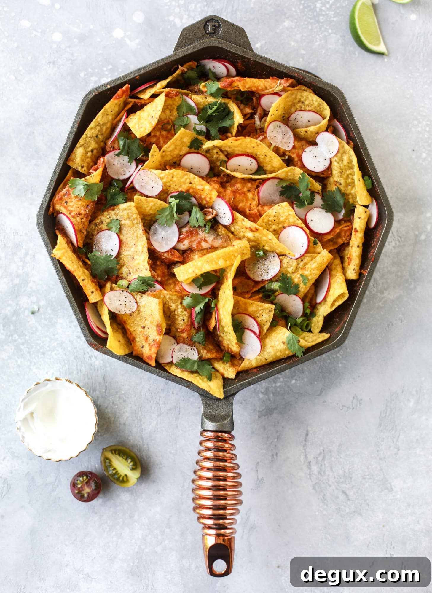This skillet of fire roasted chicken chilaquiles is so easy, flavorful and delicious! A quick blender sauce made with fire roasted tomatoes, shredded chicken, lots of tortilla chips and your favorite toppings. Give me all the cheese and guacamole! I howsweeteats.com #chicken #chilaquiles #recipe #easy #dinner