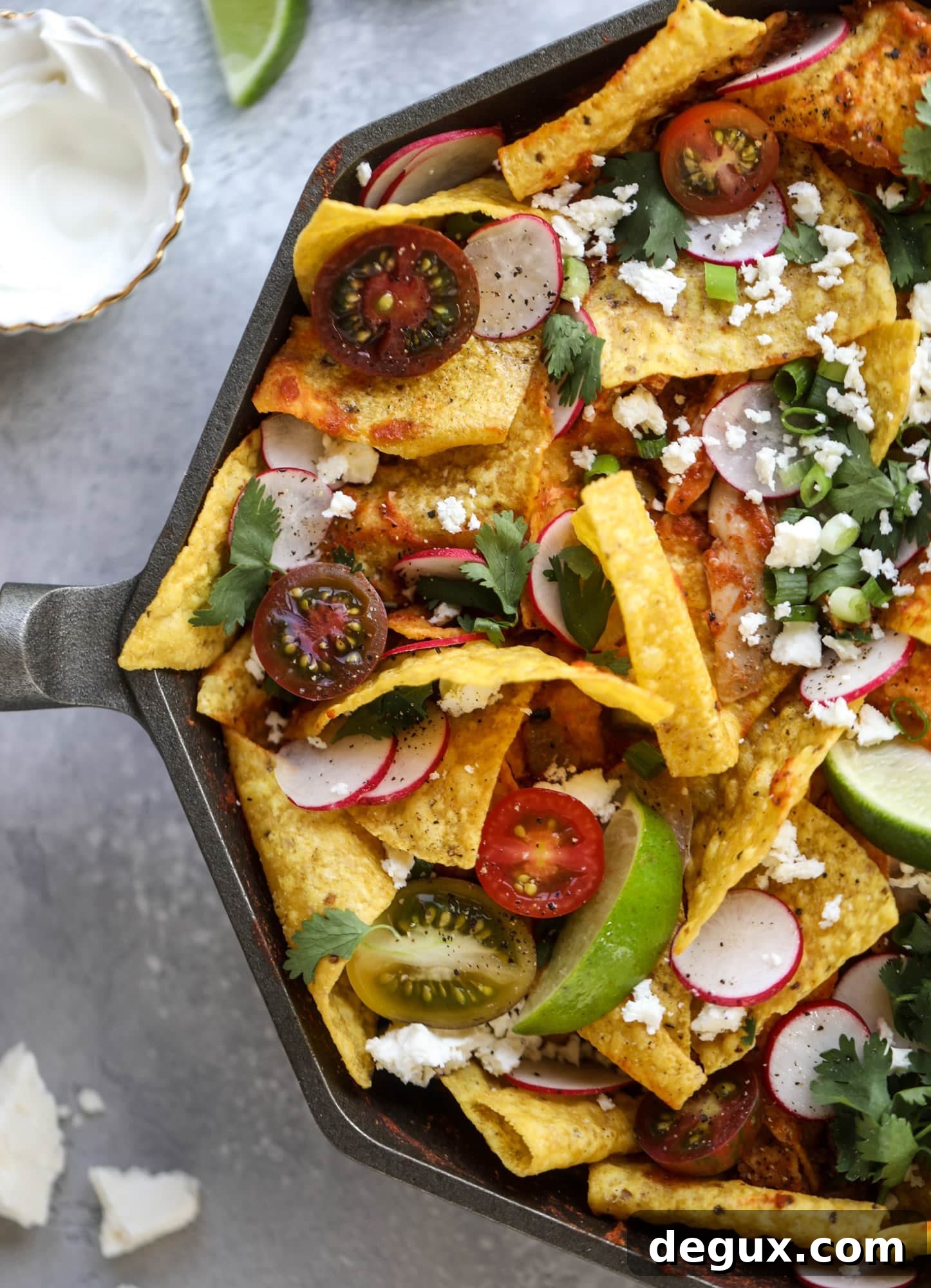 This skillet of fire roasted chicken chilaquiles is so easy, flavorful and delicious! A quick blender sauce made with fire roasted tomatoes, shredded chicken, lots of tortilla chips and your favorite toppings. Give me all the cheese and guacamole! I howsweeteats.com #chicken #chilaquiles #recipe #easy #dinner