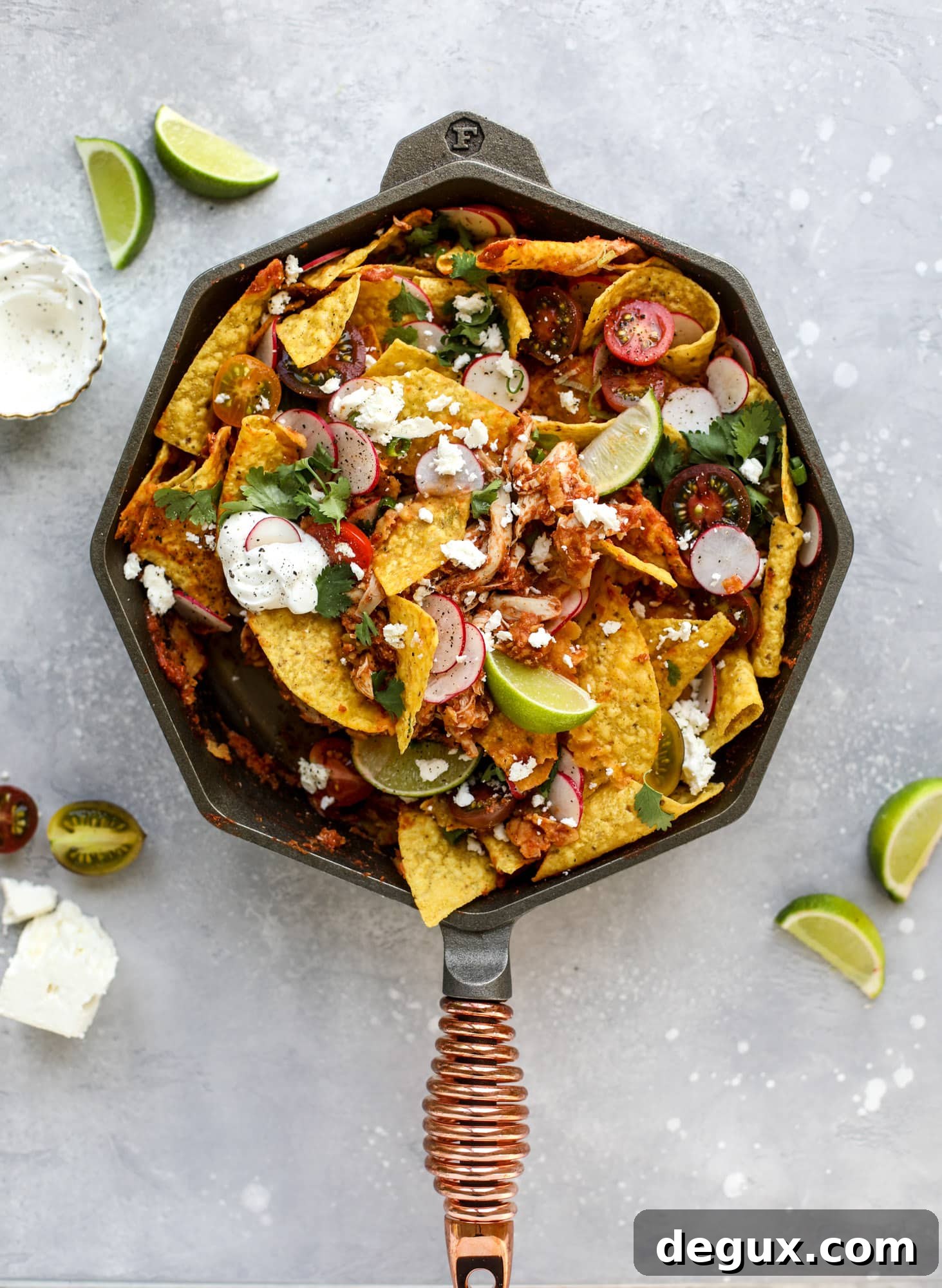 This skillet of fire roasted chicken chilaquiles is so easy, flavorful and delicious! A quick blender sauce made with fire roasted tomatoes, shredded chicken, lots of tortilla chips and your favorite toppings. Give me all the cheese and guacamole! I howsweeteats.com #chicken #chilaquiles #recipe #easy #dinner