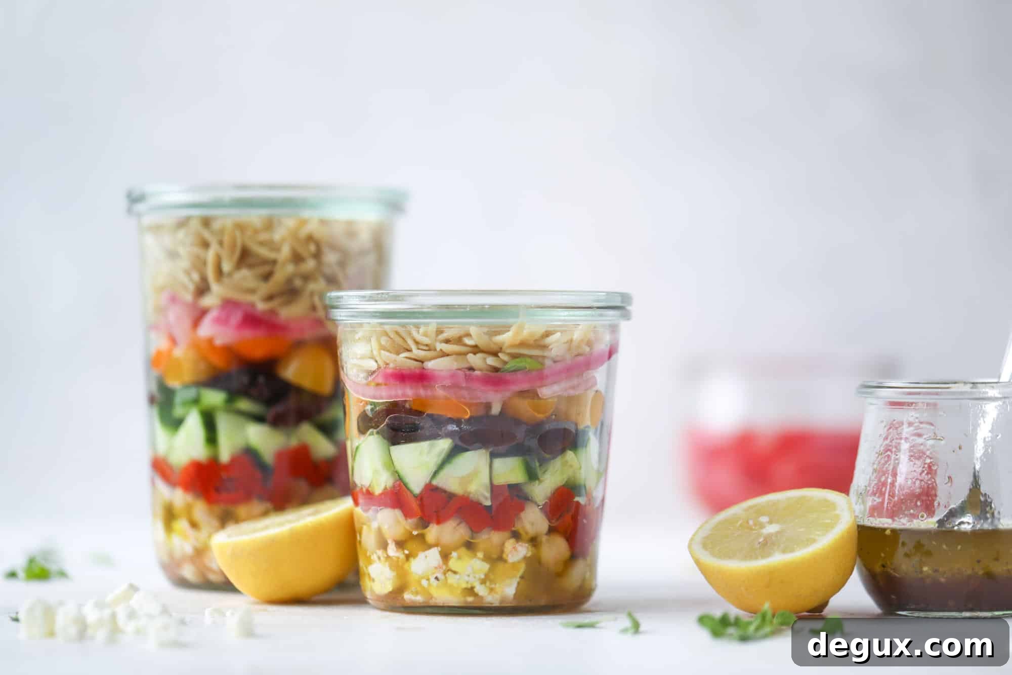 This incredible greek orzo salad in a jar is to die for! The recipe is so easy and flavorful, super satisfying and perfect for meal prep. This salad in a jar is a delicious lunch idea for the weekdays and keeps you feeling full and happy! I howsweeteats.com #salad #jar #greek #orzo #recipes #healthy #lunch #mealprep