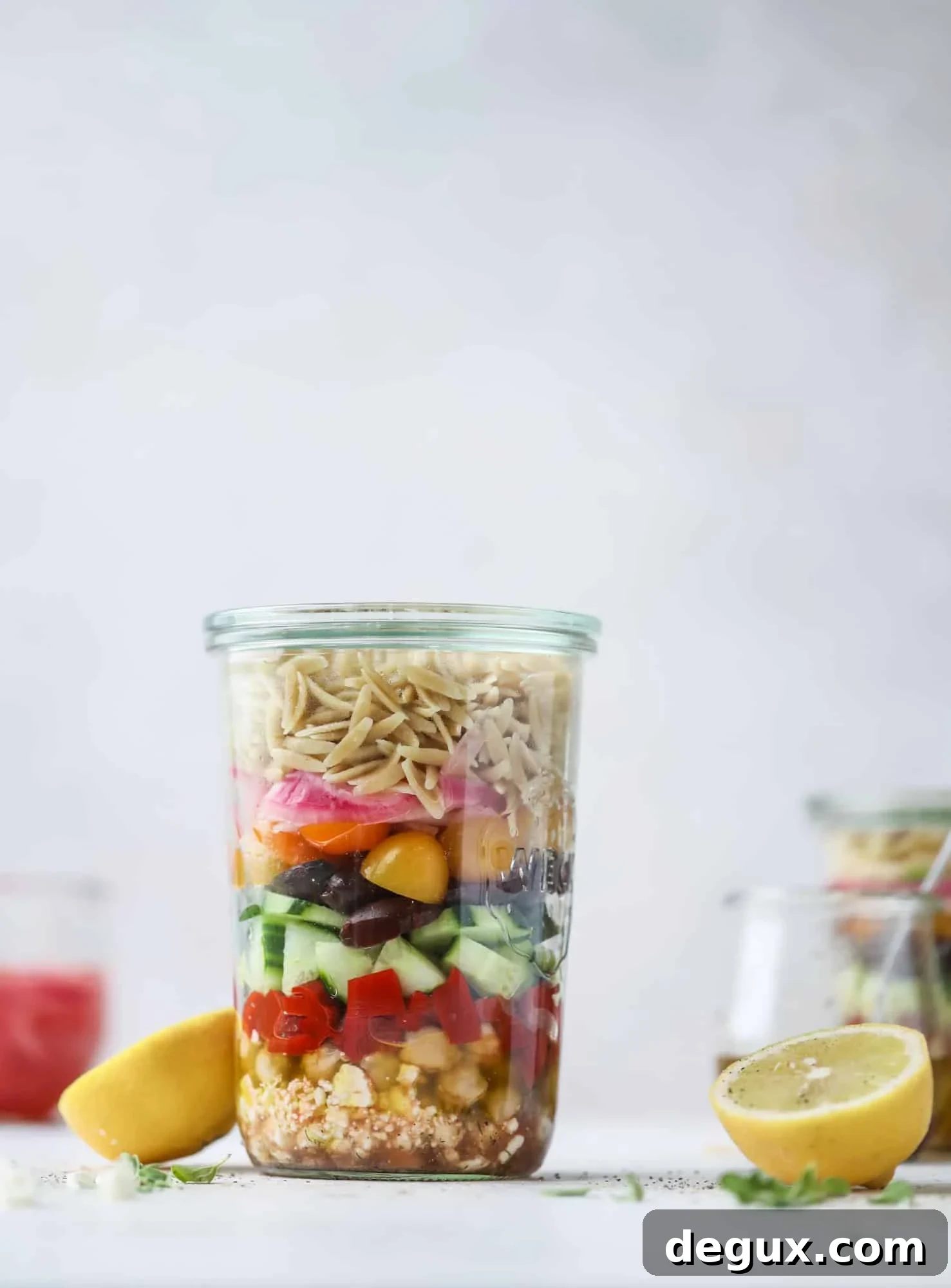 This incredible greek orzo salad in a jar is to die for! The recipe is so easy and flavorful, super satisfying and perfect for meal prep. This salad in a jar is a delicious lunch idea for the weekdays and keeps you feeling full and happy! I howsweeteats.com #salad #jar #greek #orzo #recipes #healthy #lunch #mealprep