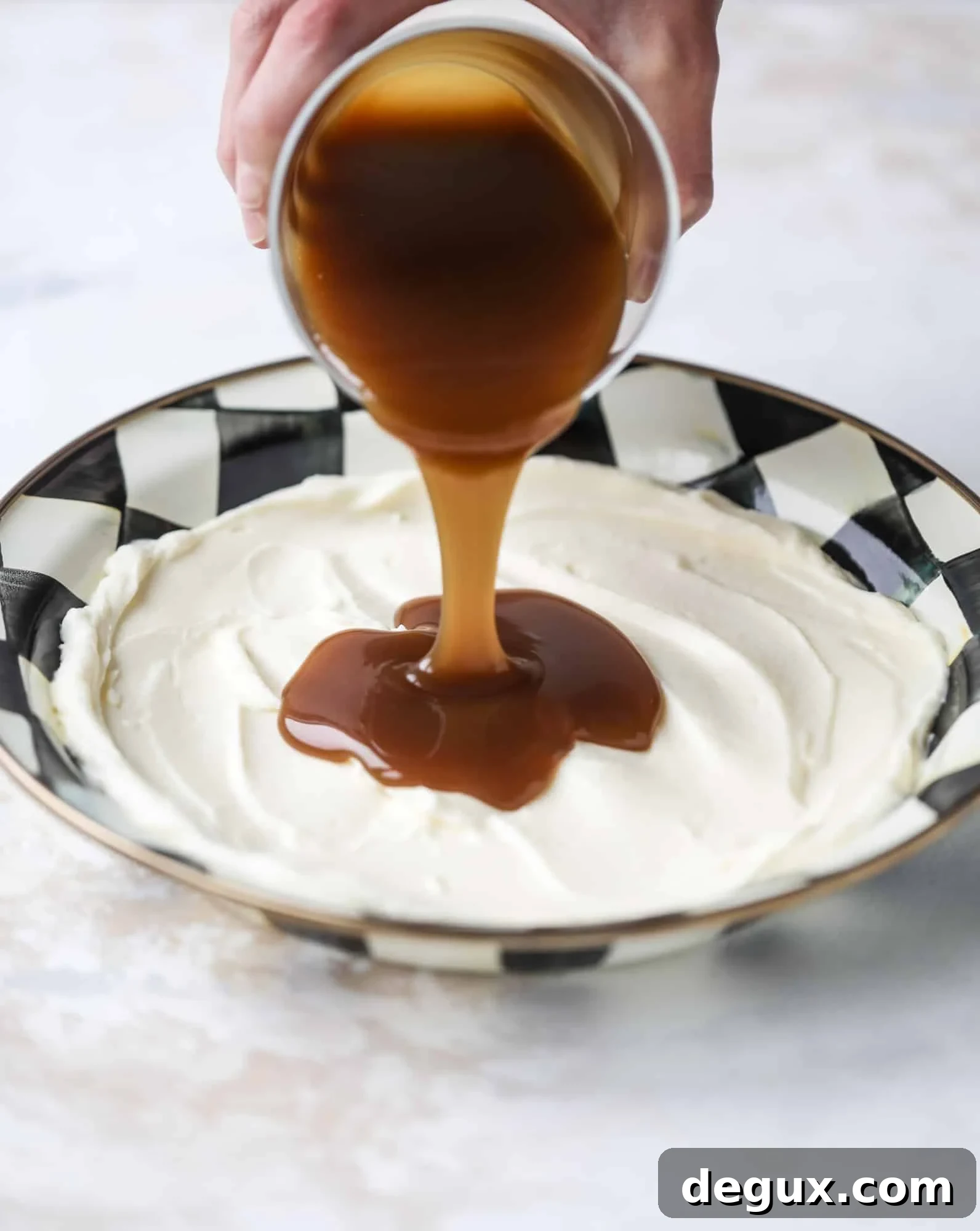 This caramel apple dip is my take on the old-school cream cheese based dip that is super delicious! Here, we have a mascarpone base with a bourbon caramel sauce, topped with roasted chopped cashews. Just add apples! I howsweeteats.com #caramel #apple #dip #appetizer #snack