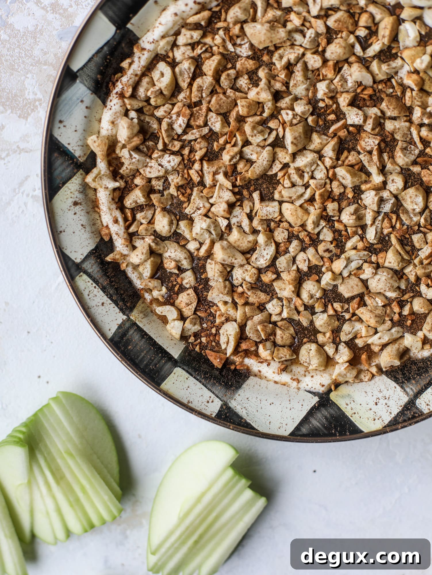 This caramel apple dip is my take on the old-school cream cheese based dip that is super delicious! Here, we have a mascarpone base with a bourbon caramel sauce, topped with roasted chopped cashews. Just add apples! I howsweeteats.com #caramel #apple #dip #appetizer #snack
