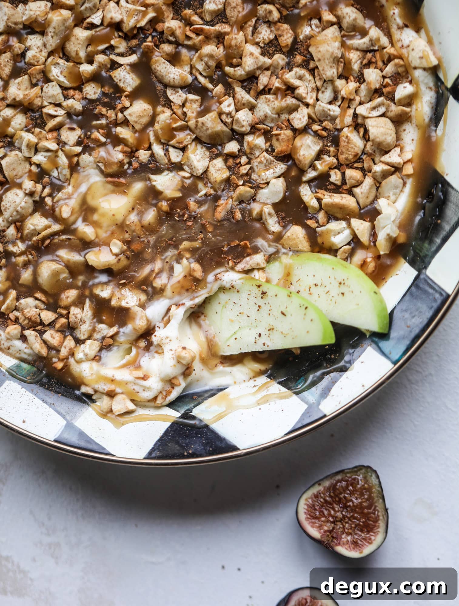 This caramel apple dip is my take on the old-school cream cheese based dip that is super delicious! Here, we have a mascarpone base with a bourbon caramel sauce, topped with roasted chopped cashews. Just add apples! I howsweeteats.com #caramel #apple #dip #appetizer #snack