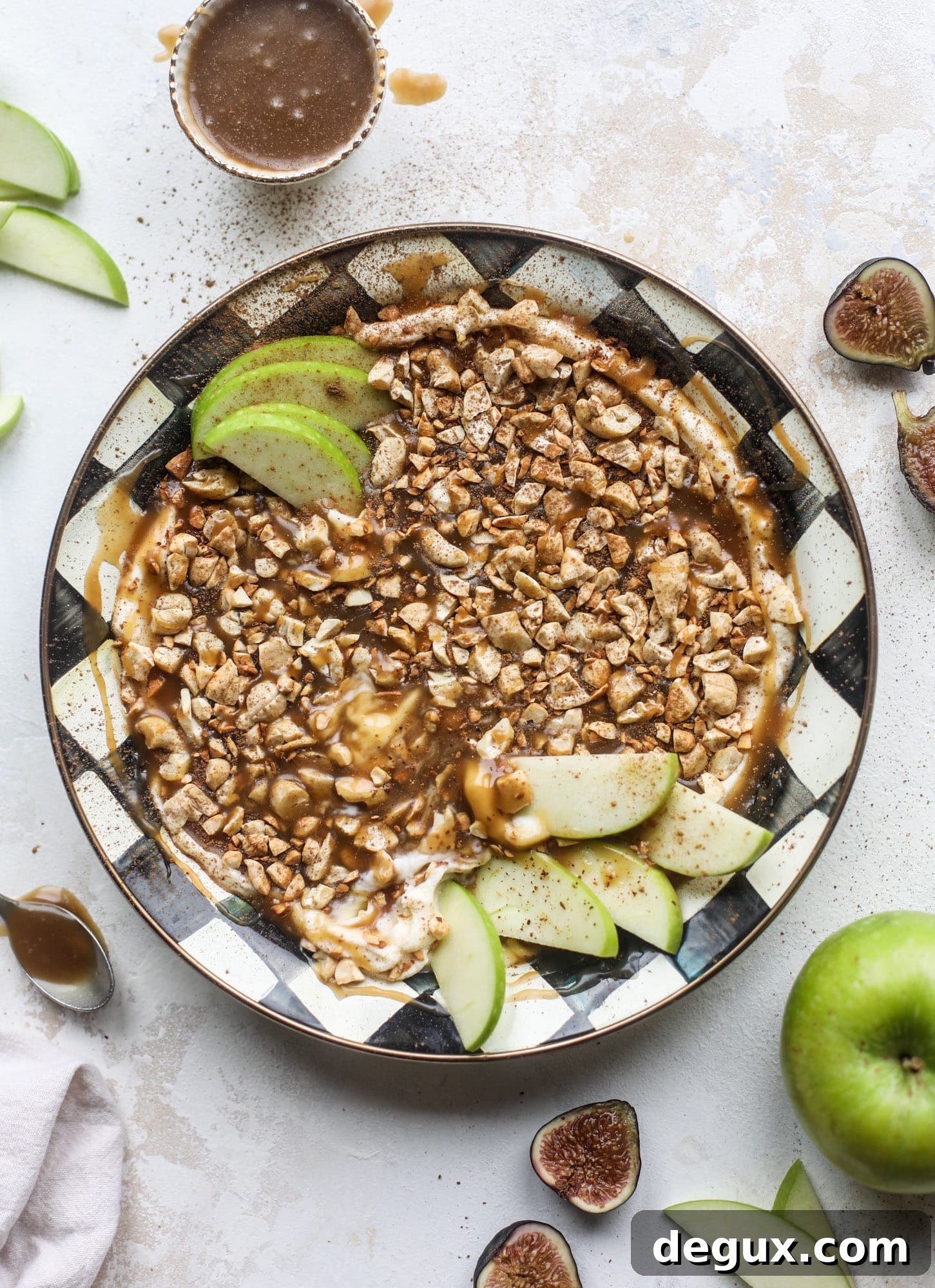 This caramel apple dip is my take on the old-school cream cheese based dip that is super delicious! Here, we have a mascarpone base with a bourbon caramel sauce, topped with roasted chopped cashews. Just add apples! I howsweeteats.com #caramel #apple #dip #appetizer #snack