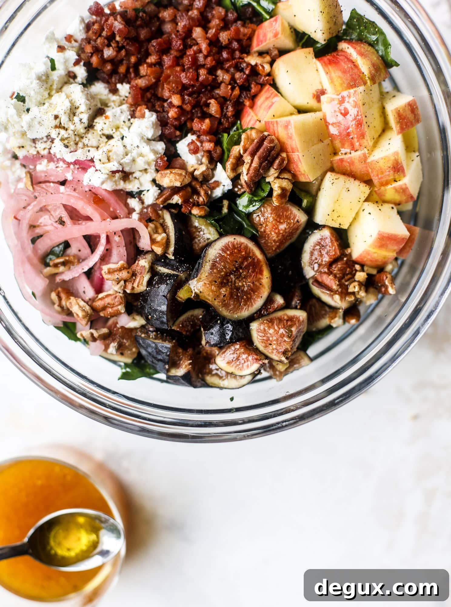 This fall kale salad is perfect for the season and full of so much delicious flavor! Shredded kale, honeycrisp apple, fresh figs, pancetta, pickled onions, pecans and goat cheese come together with a maple cider vinaigrette for salad heaven. I howsweeteats.com #fall #kale #salad #apples #figs #pecans
