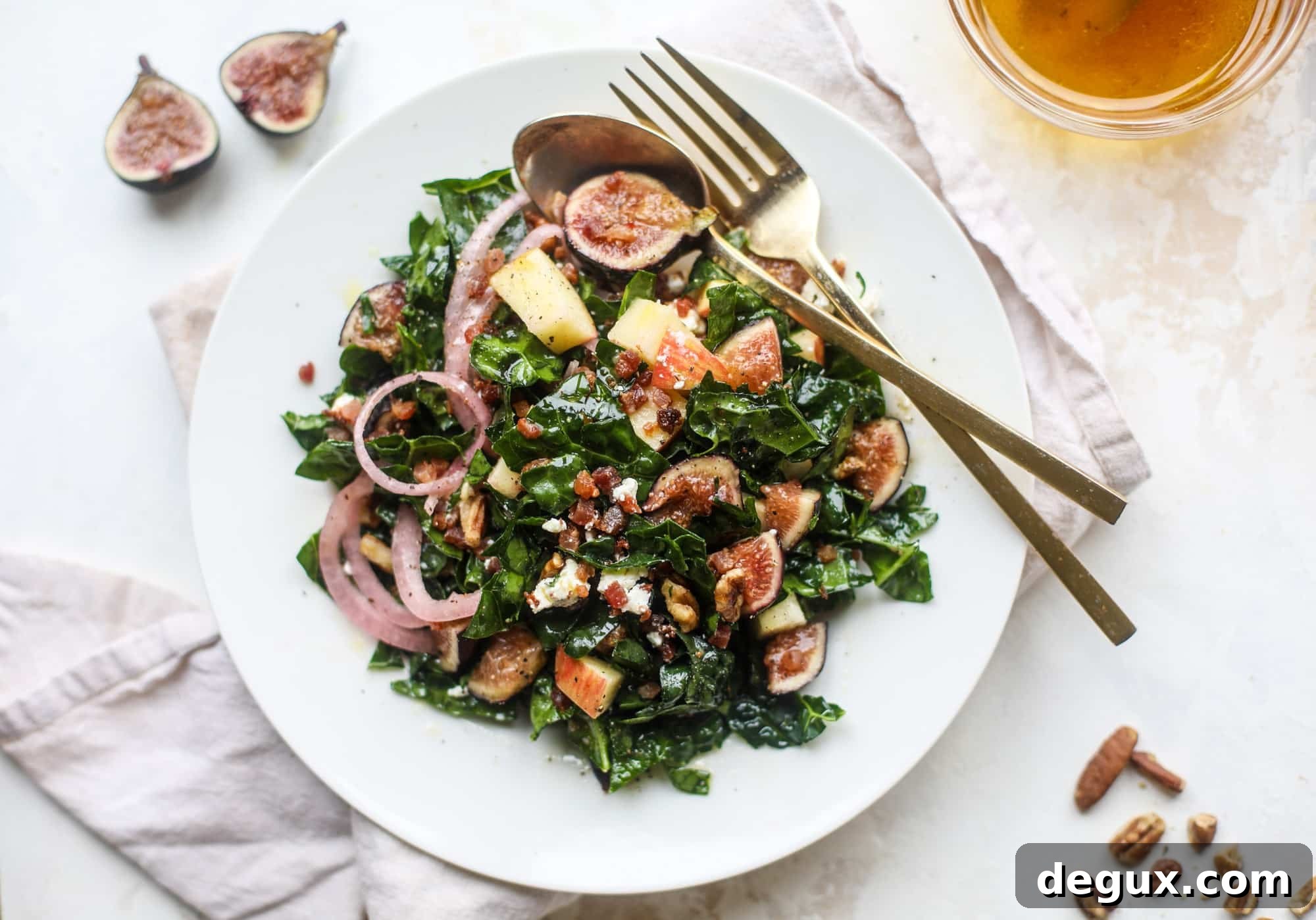 This fall kale salad is perfect for the season and full of so much delicious flavor! Shredded kale, honeycrisp apple, fresh figs, pancetta, pickled onions, pecans and goat cheese come together with a maple cider vinaigrette for salad heaven. I howsweeteats.com #fall #kale #salad #apples #figs #pecans
