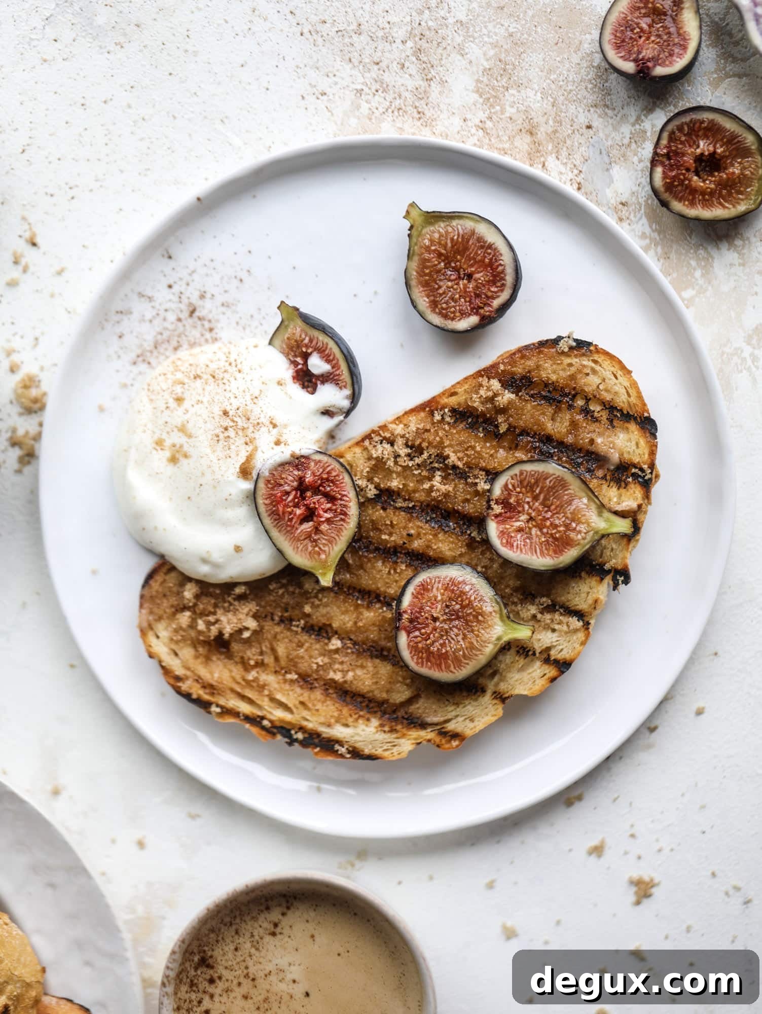 Grilled Cinnamon Toast with Fig Slices and Creamy Ricotta 6 This cinnamon sugar toast is an absolutely dream! It's spread with a cinnamon brown sugar butter, grilled to perfection and served with creamy whipped ricotta cheese, fresh figs, honey, cinnamon and sliced almonds. I howsweeteats.com #cinnamon #sugar #toast #ricotta #figs #breakfast