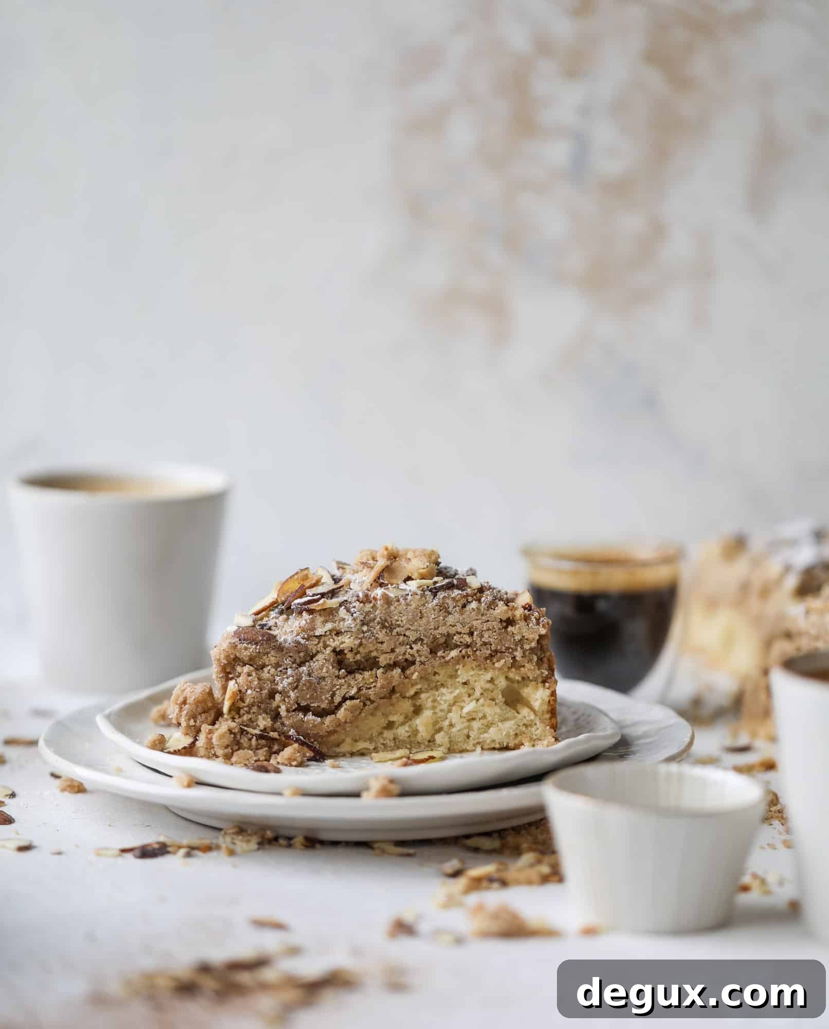This almond crumb cake is so delicious and perfect for breakfast or dessert! It's full of delicious almond flavor and crunch and the crumb on top is so thick and perfect. It's like an almond croissant on steroids. I howsweeteats.com #almond #crumb #cake