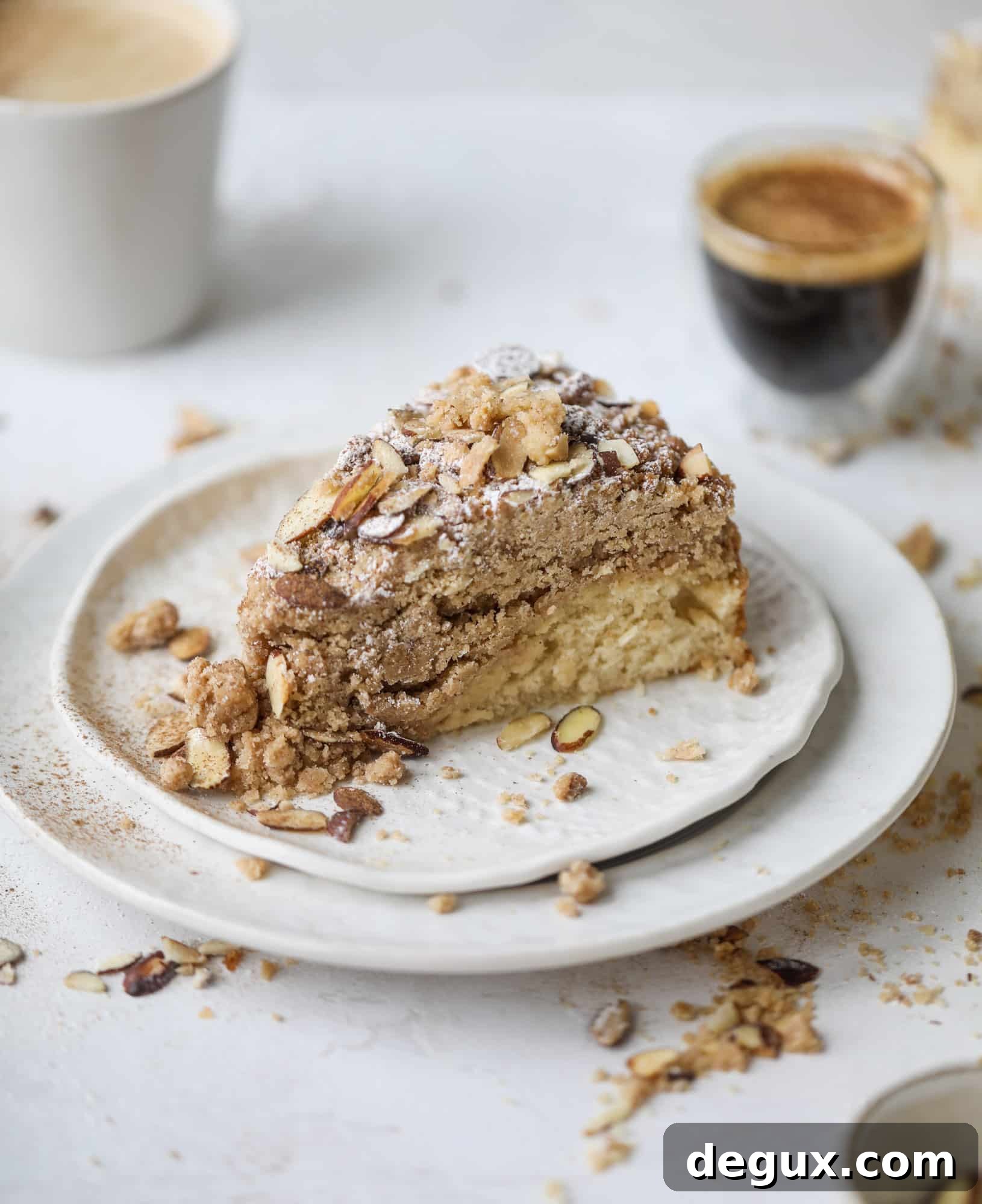 This almond crumb cake is so delicious and perfect for breakfast or dessert! It's full of delicious almond flavor and crunch and the crumb on top is so thick and perfect. It's like an almond croissant on steroids. I howsweeteats.com #almond #crumb #cake