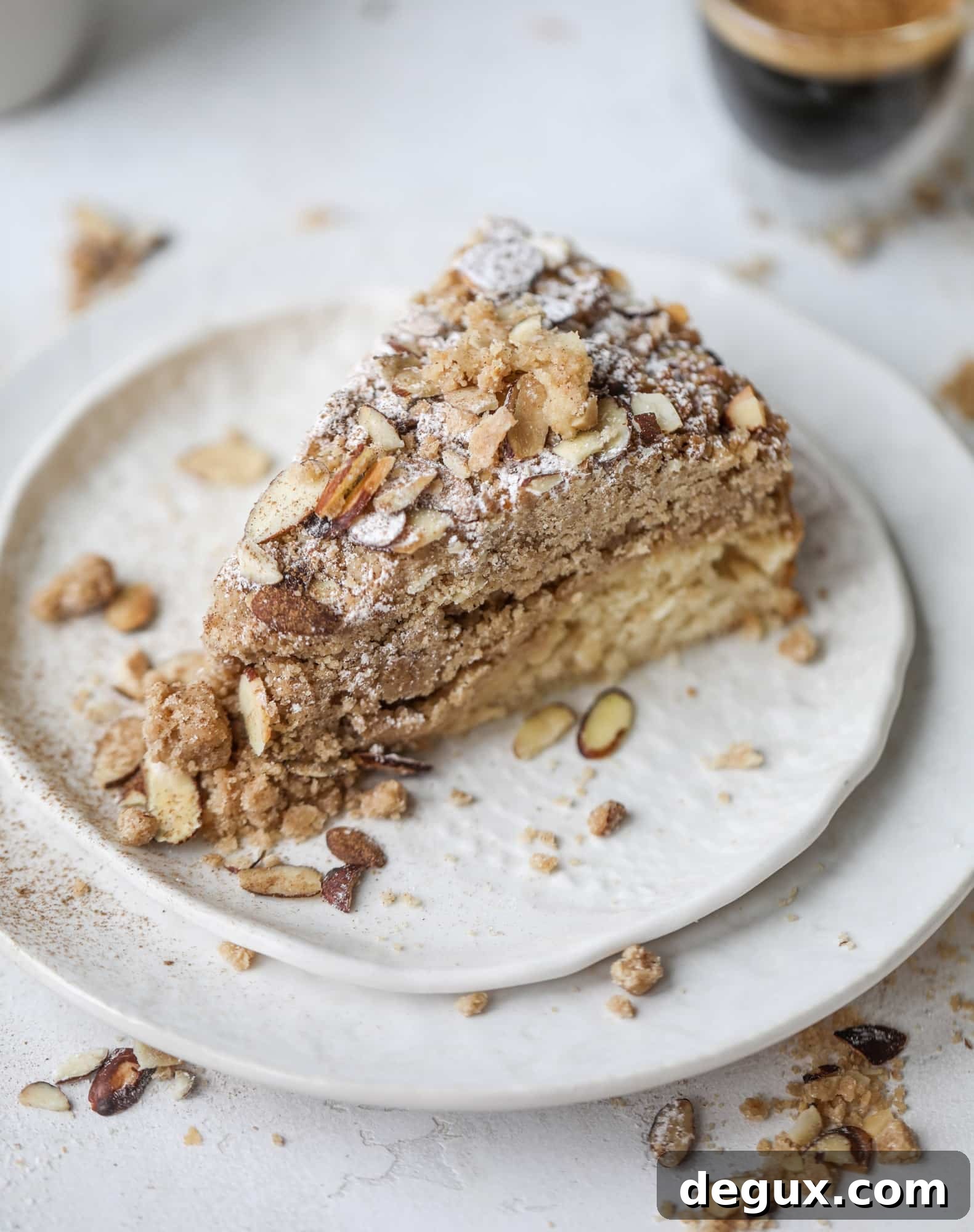This almond crumb cake is so delicious and perfect for breakfast or dessert! It's full of delicious almond flavor and crunch and the crumb on top is so thick and perfect. It's like an almond croissant on steroids. I howsweeteats.com #almond #crumb #cake
