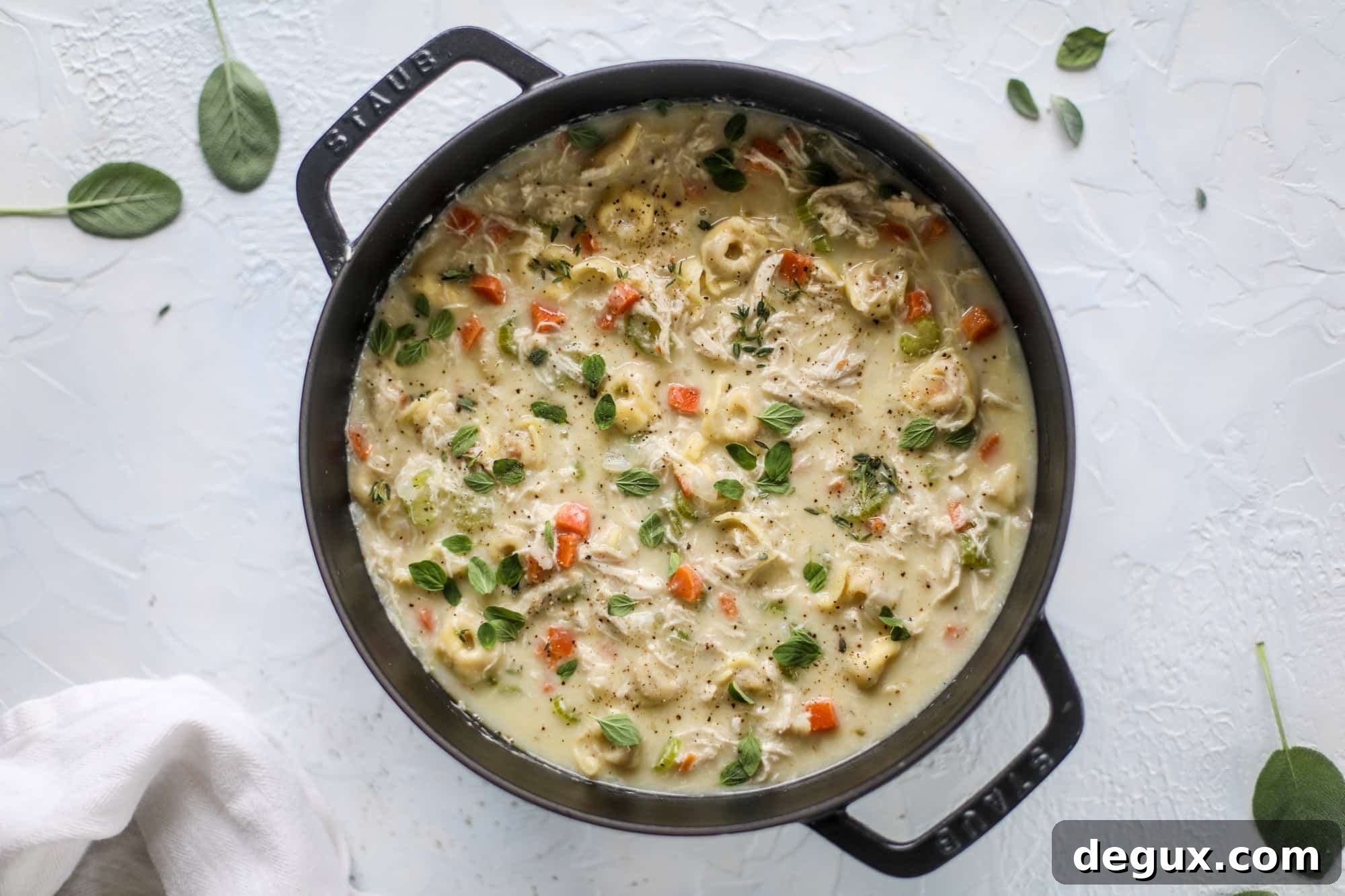 This creamy chicken tortellini soup is the perfect weeknight meal! It comes together quickly and is a great meal to use up a rotisserie chicken. It's satisfying and hearty, with tortellini replacing egg noodles for the pasta. Comfort food perfection! I howsweeteats.com #chicken #soup