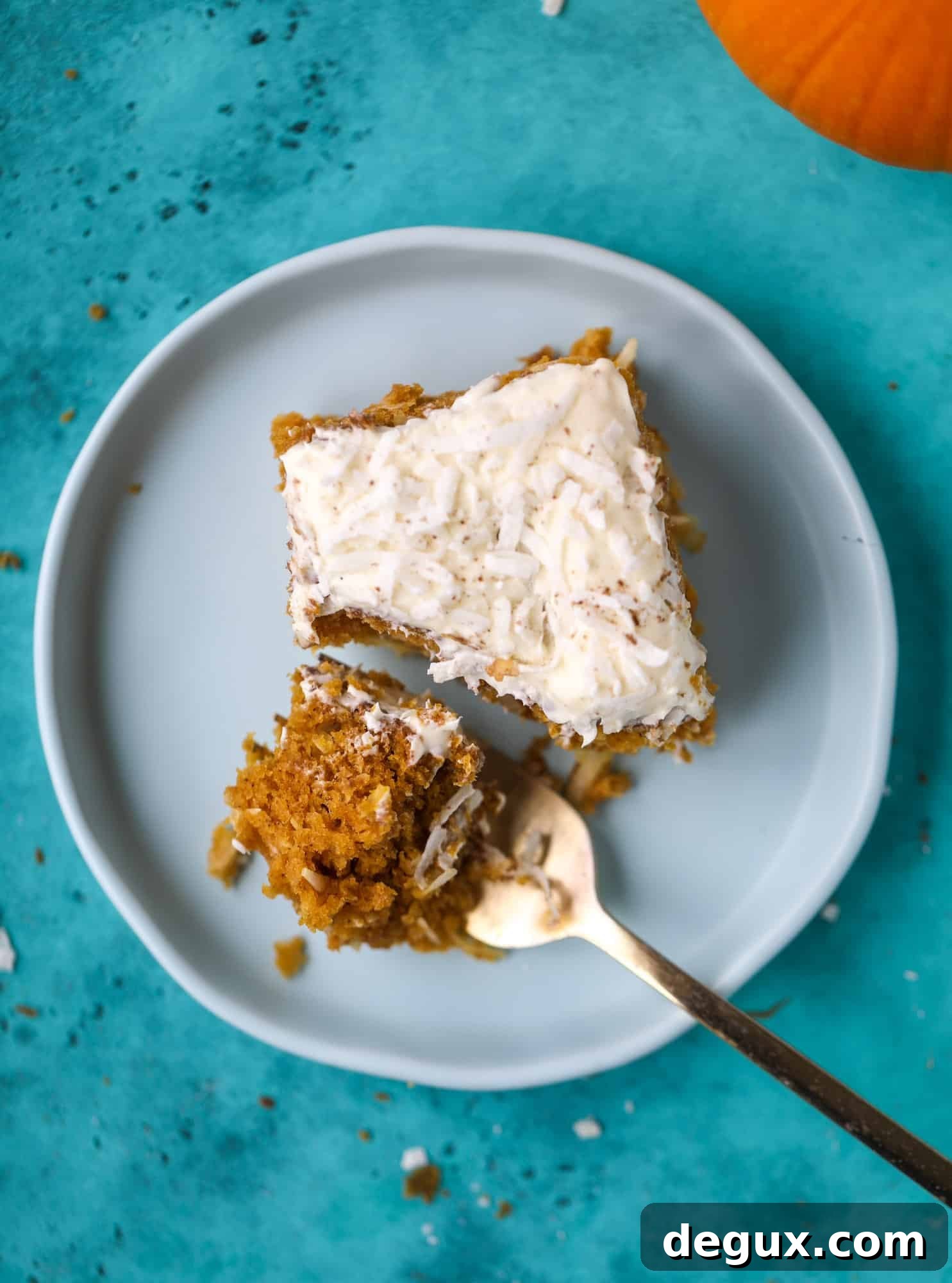 This pumpkin coconut cake is super tender and delicious and comes together quickly in a baking dish! It's spiced for the season and covered in a fluffy coconut cream cheese frosting. You can made it ahead of time for a crowd and it's a huge hit! I howsweeteats.com #pumpkin #cake