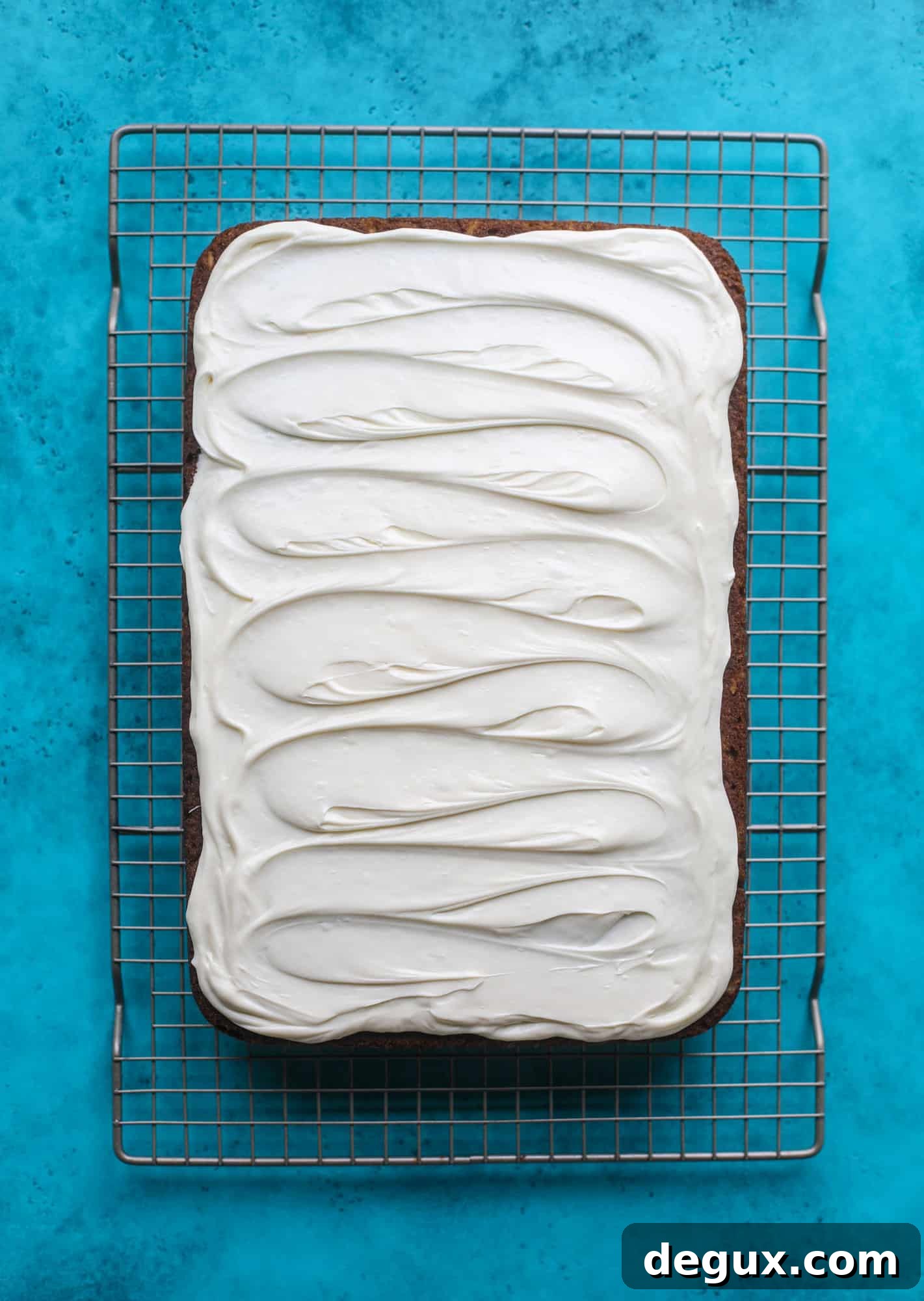This pumpkin coconut cake is super tender and delicious and comes together quickly in a baking dish! It's spiced for the season and covered in a fluffy coconut cream cheese frosting. You can made it ahead of time for a crowd and it's a huge hit! I howsweeteats.com #pumpkin #cake