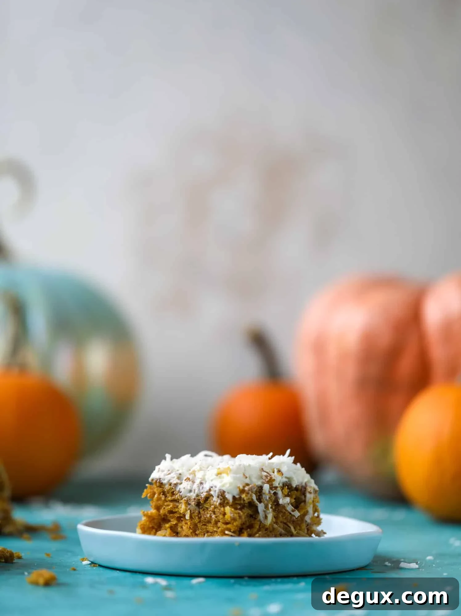 This pumpkin coconut cake is super tender and delicious and comes together quickly in a baking dish! It's spiced for the season and covered in a fluffy coconut cream cheese frosting. You can made it ahead of time for a crowd and it's a huge hit! I howsweeteats.com #pumpkin #cake