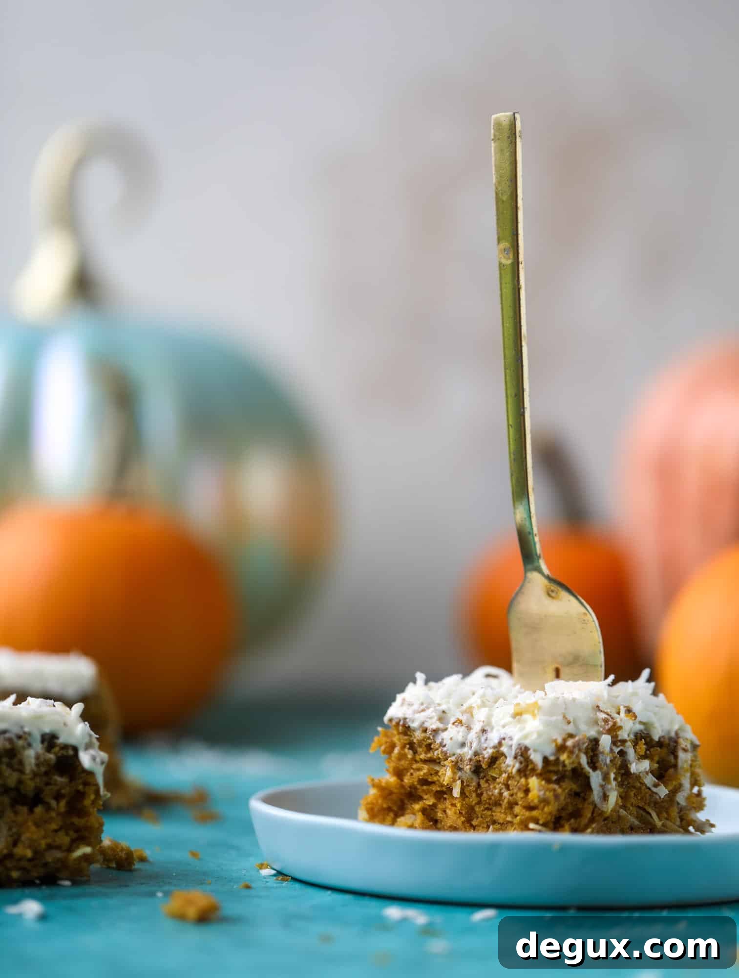 This pumpkin coconut cake is super tender and delicious and comes together quickly in a baking dish! It's spiced for the season and covered in a fluffy coconut cream cheese frosting. You can made it ahead of time for a crowd and it's a huge hit! I howsweeteats.com #pumpkin #cake