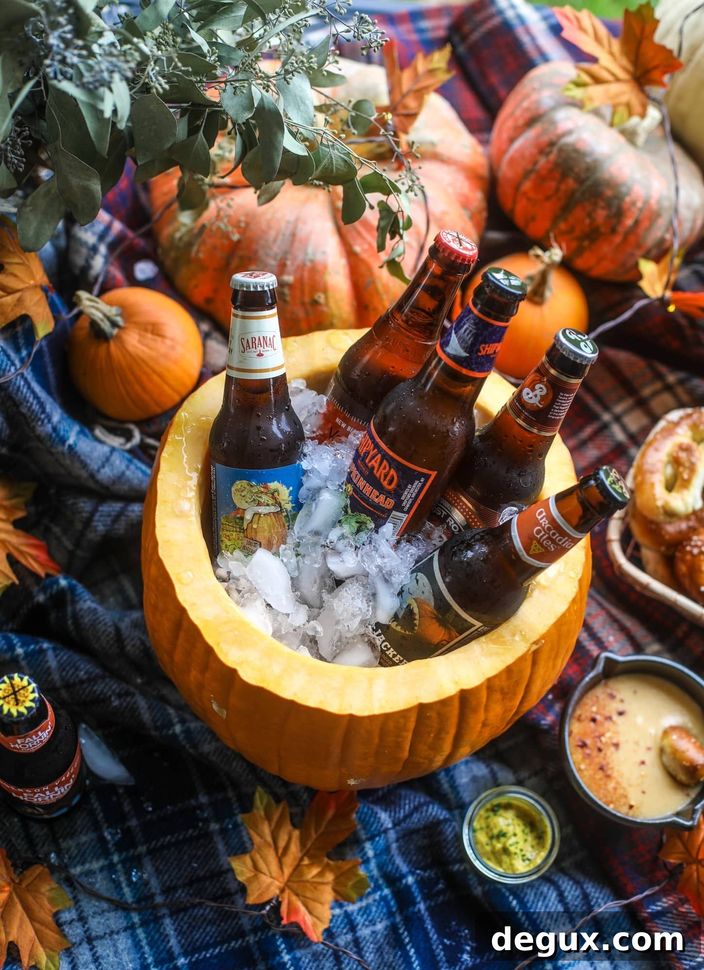 This is the cutest way ever to serve the best pumpkin beer! If you do a pumpkin beer party of a pumpkin beer tasting, this pumpkin cooler is an adorable (and easy!) way to make things festive. Kick it up with a hot pretzel bar and lots of dipping sauce too! I howsweeteats.com #pumpkin #beer #cooler #softpretzel #fall #cheese