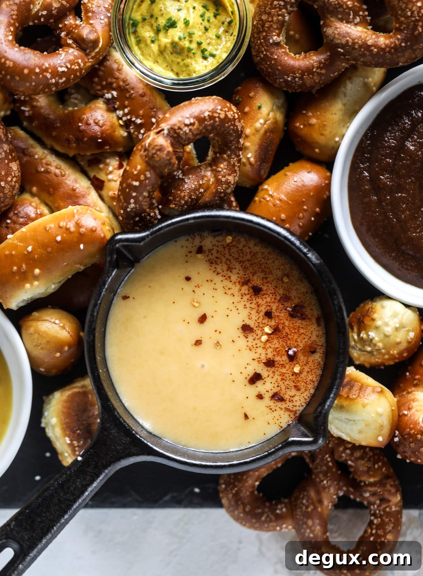This is the cutest way ever to serve the best pumpkin beer! If you do a pumpkin beer party of a pumpkin beer tasting, this pumpkin cooler is an adorable (and easy!) way to make things festive. Kick it up with a hot pretzel bar and lots of dipping sauce too! I howsweeteats.com #pumpkin #beer #cooler #softpretzel #fall #cheese
