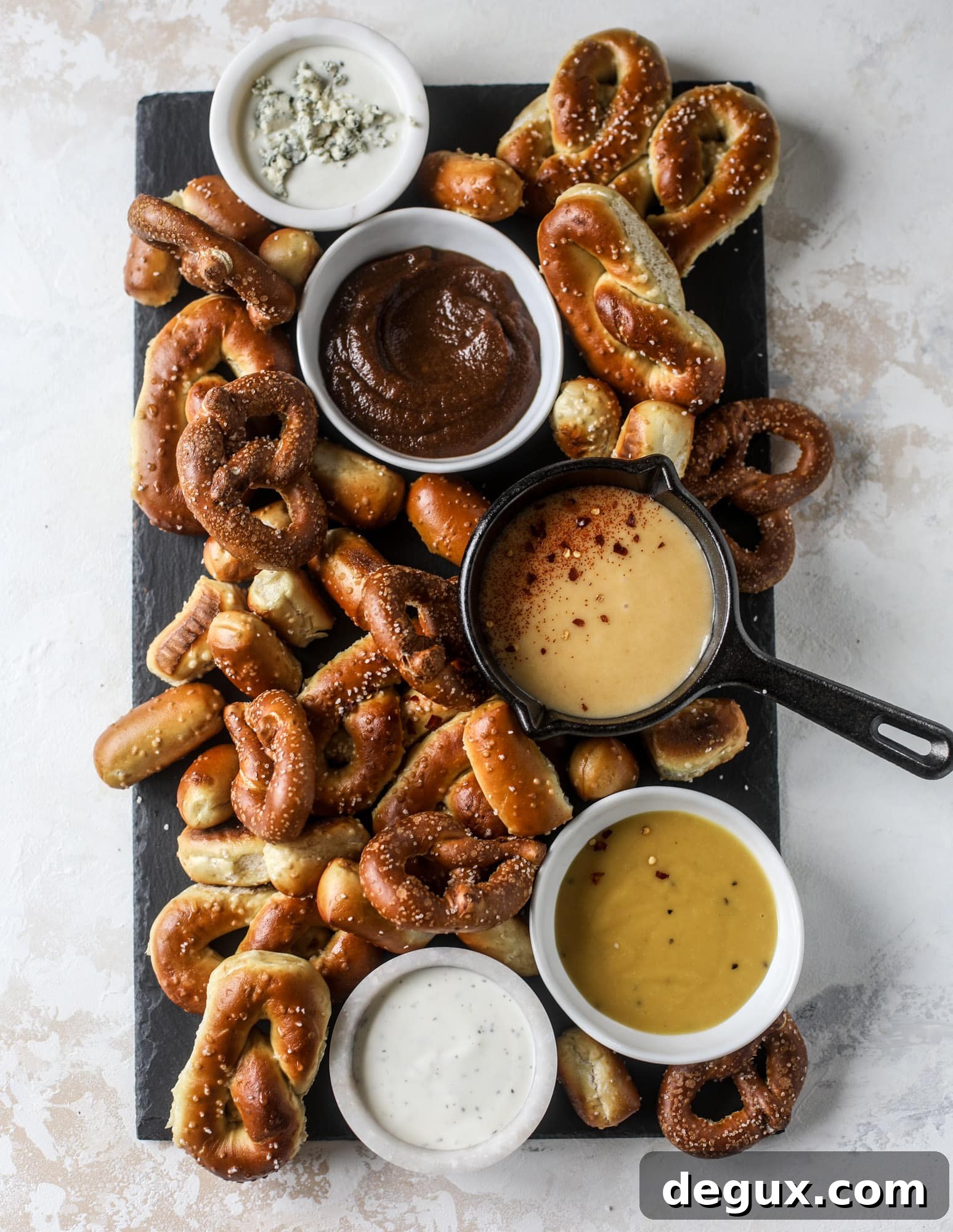 This is the cutest way ever to serve the best pumpkin beer! If you do a pumpkin beer party of a pumpkin beer tasting, this pumpkin cooler is an adorable (and easy!) way to make things festive. Kick it up with a hot pretzel bar and lots of dipping sauce too! I howsweeteats.com #pumpkin #beer #cooler #softpretzel #fall #cheese