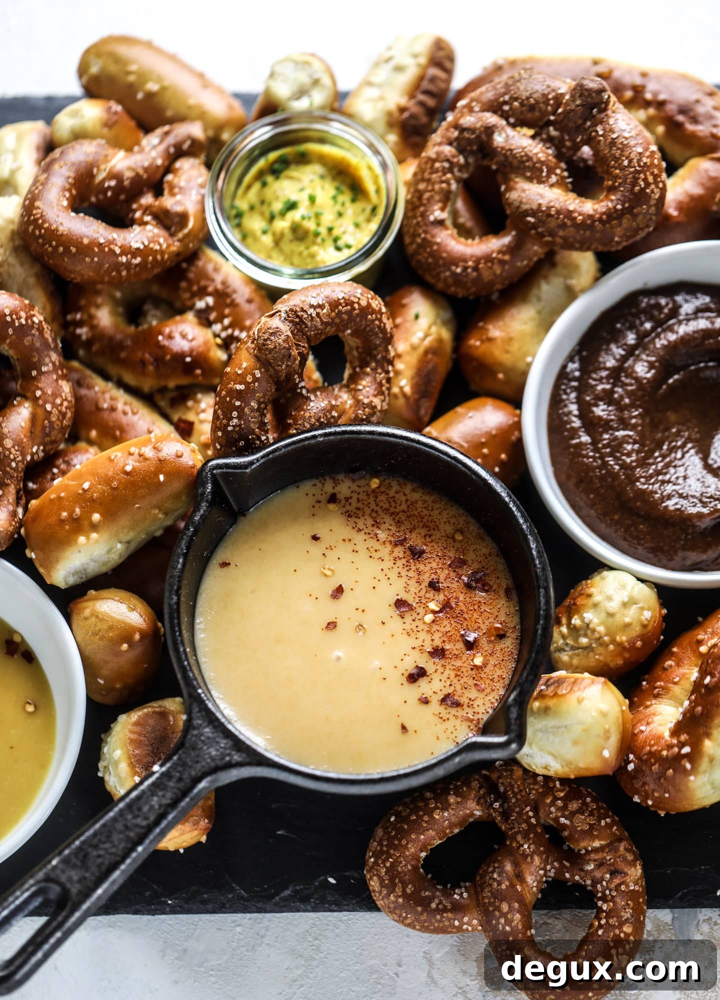This is the cutest way ever to serve the best pumpkin beer! If you do a pumpkin beer party of a pumpkin beer tasting, this pumpkin cooler is an adorable (and easy!) way to make things festive. Kick it up with a hot pretzel bar and lots of dipping sauce too! I howsweeteats.com #pumpkin #beer #cooler #softpretzel #fall #cheese