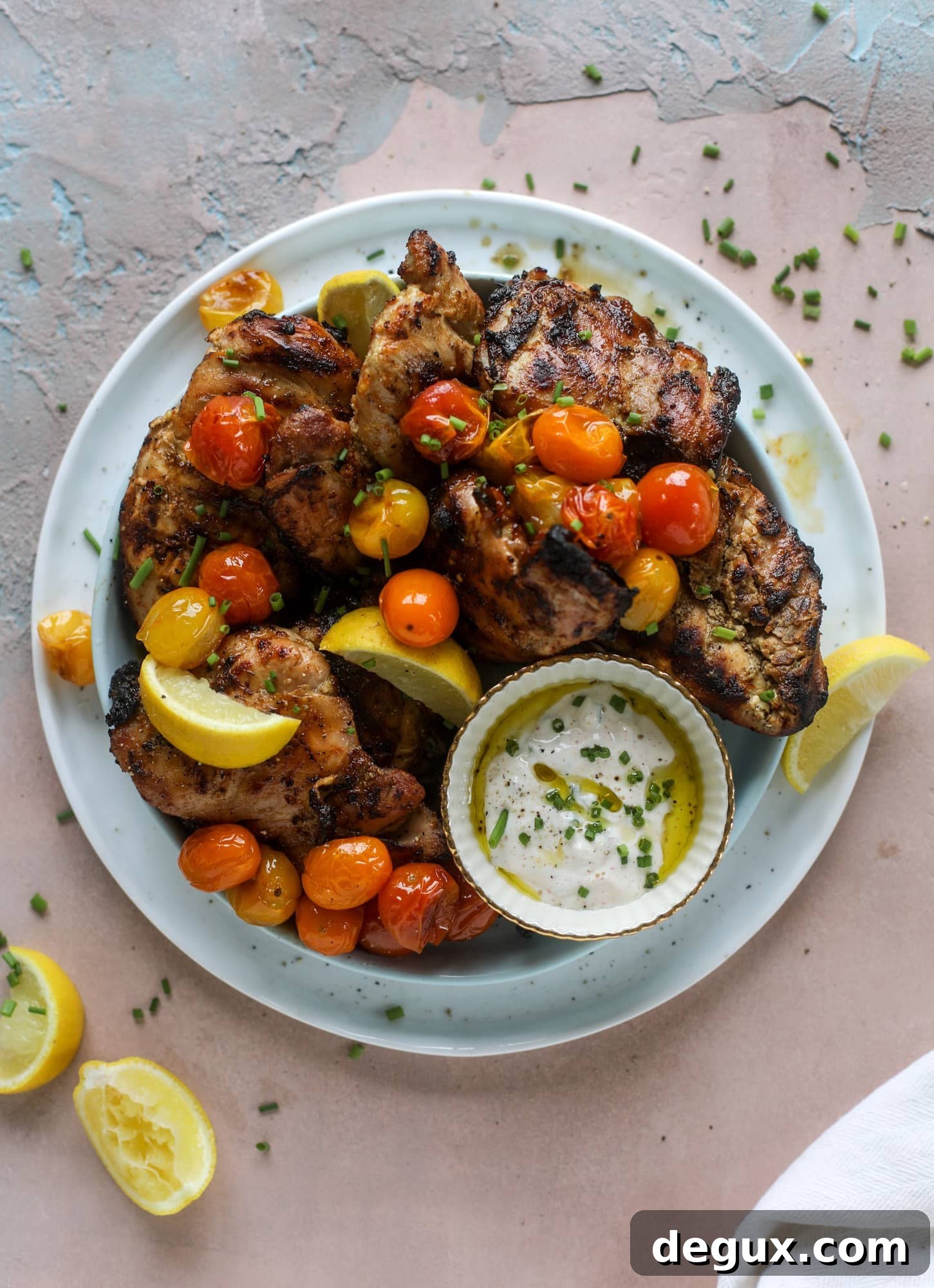 Lemon Yogurt Marinated Grilled Chicken Recipe 2 This yogurt marinated chicken recipe is super flavorful, tender, juicy and delicious. The fresh lemon adds a kick of flavor and it's a versatile recipe you can make for lunch or dinner. Grill it and serve with your favorite side, then use the leftovers for lunch! I howsweeteats.com #yogurt #chicken #lemon #grilled #healthy #recipes