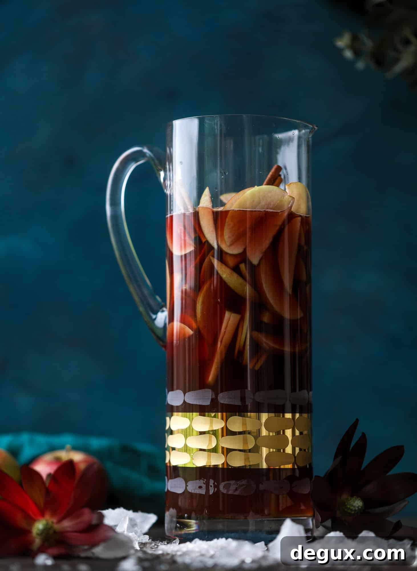 Close-up of red apple cider sangria with apple slices floating.