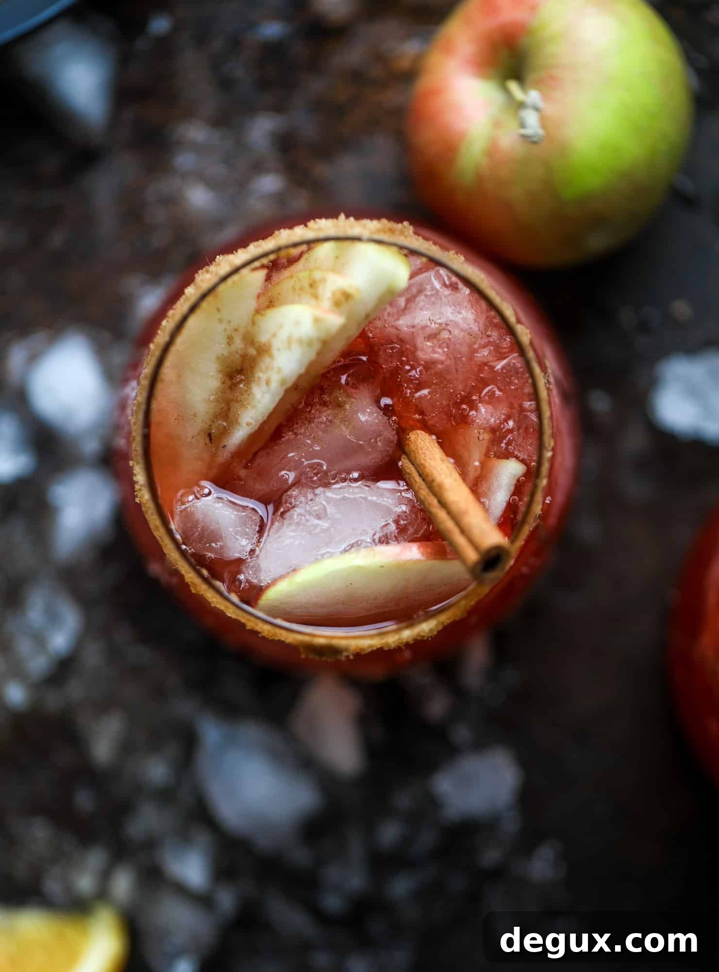Glasses and pitcher of red apple cider sangria ready to serve.