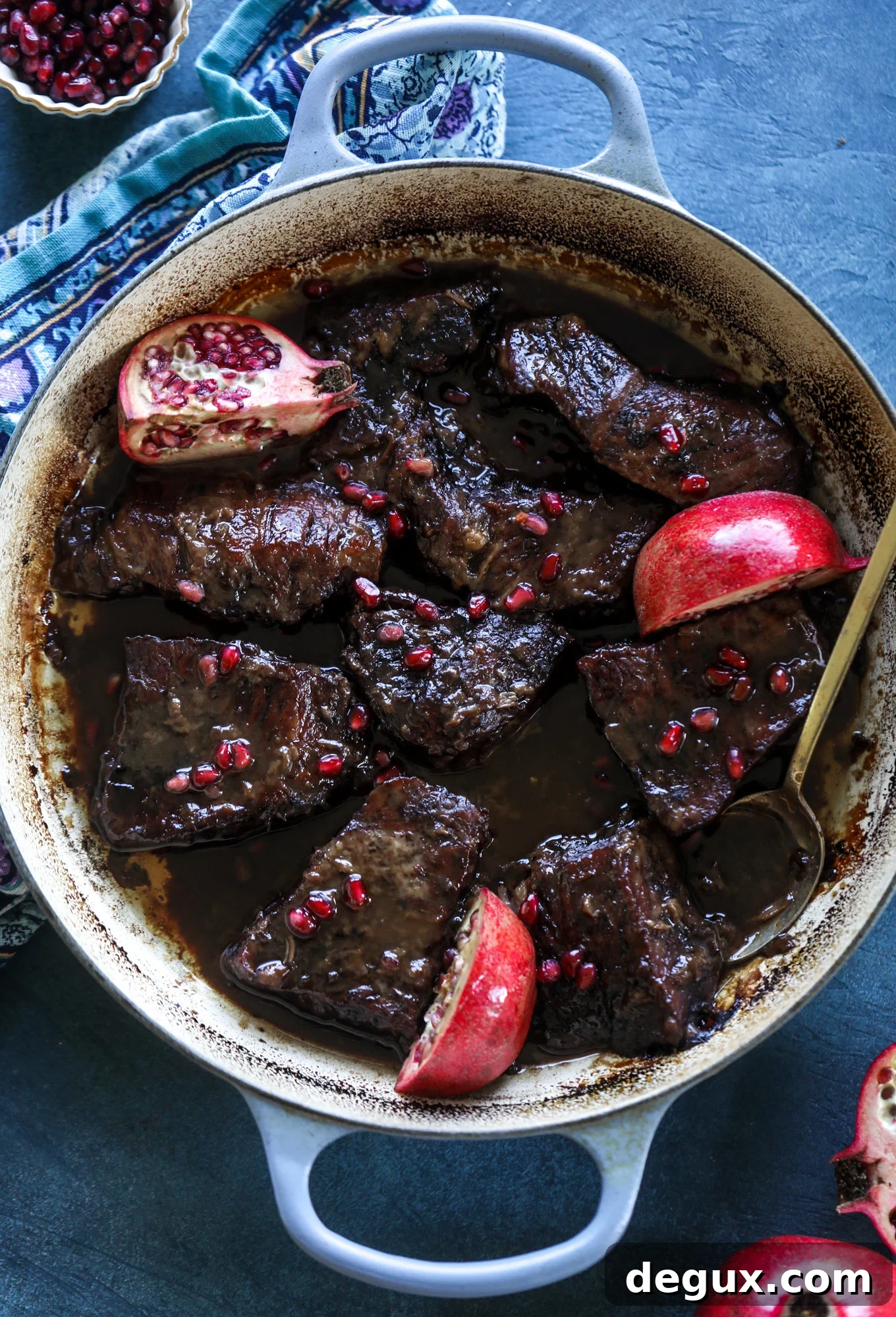 These pomegranate braised short ribs are an incredible take on comfort food! Pomegranate juice and molasses are the base of the recipe and after braising, you're left with tender, juicy and flavorful beef that is amazing served with polenta, potatoes or even in tacos. I howsweeteats.com #braised #shortribs
