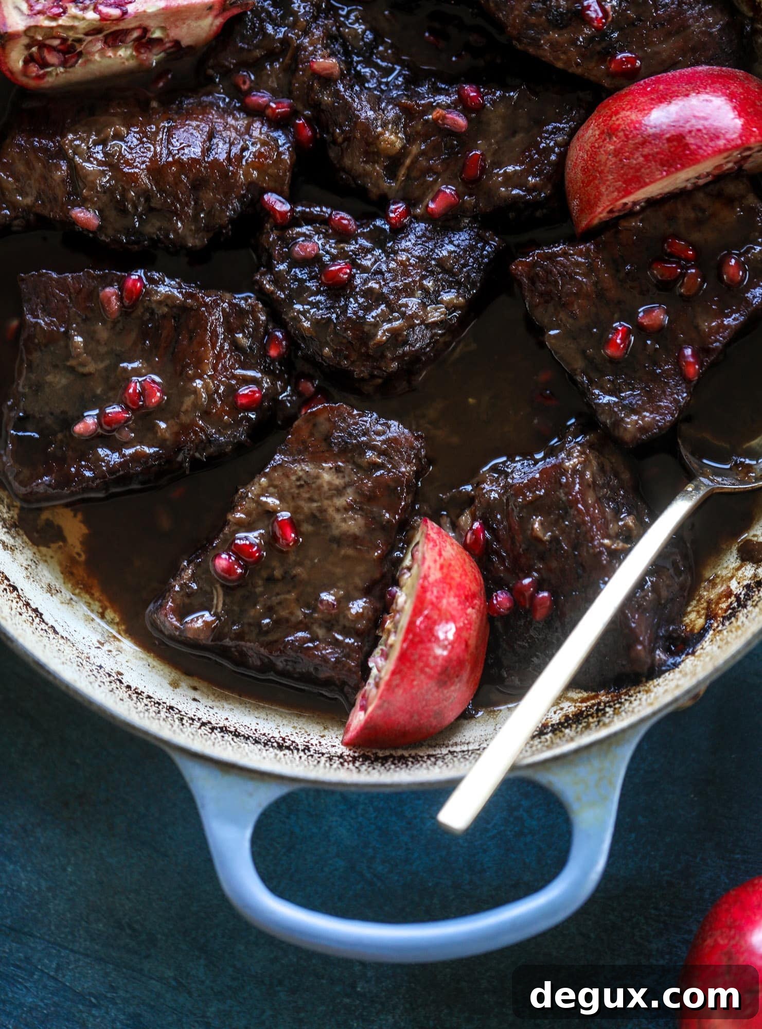 These pomegranate braised short ribs are an incredible take on comfort food! Pomegranate juice and molasses are the base of the recipe and after braising, you're left with tender, juicy and flavorful beef that is amazing served with polenta, potatoes or even in tacos. I howsweeteats.com #braised #shortribs