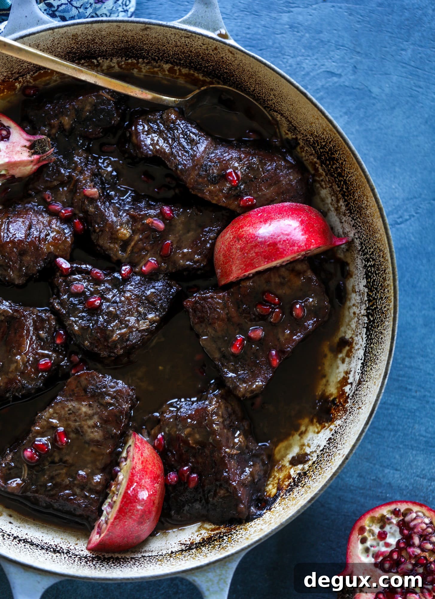 These pomegranate braised short ribs are an incredible take on comfort food! Pomegranate juice and molasses are the base of the recipe and after braising, you're left with tender, juicy and flavorful beef that is amazing served with polenta, potatoes or even in tacos. I howsweeteats.com #braised #shortribs