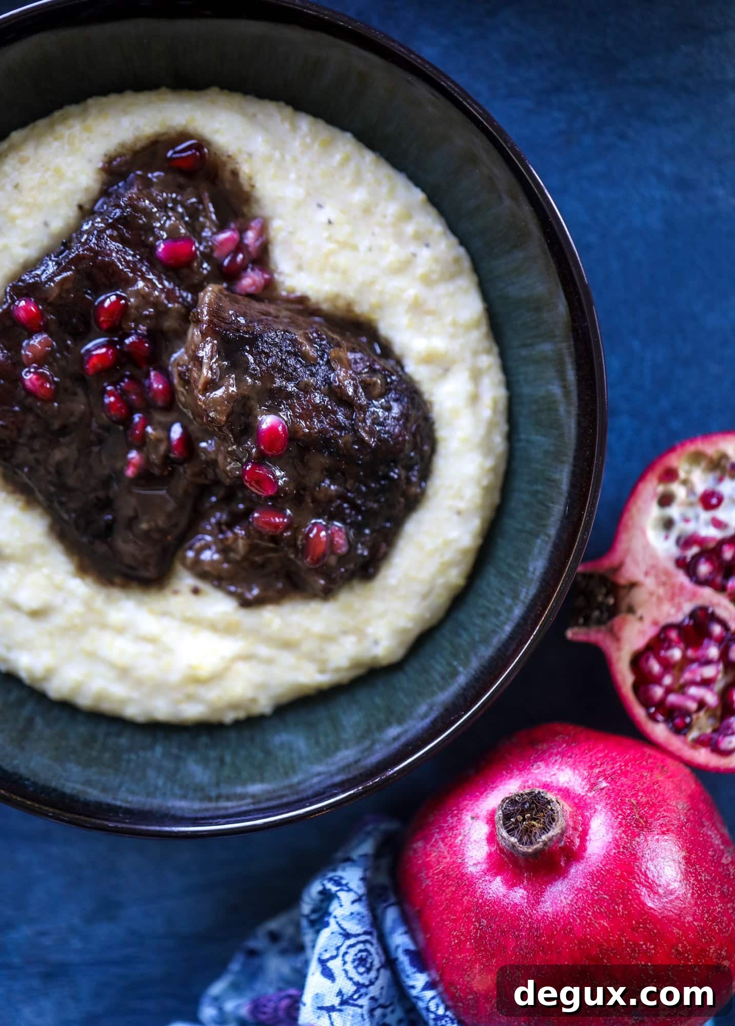 These pomegranate braised short ribs are an incredible take on comfort food! Pomegranate juice and molasses are the base of the recipe and after braising, you're left with tender, juicy and flavorful beef that is amazing served with polenta, potatoes or even in tacos. I howsweeteats.com #braised #shortribs