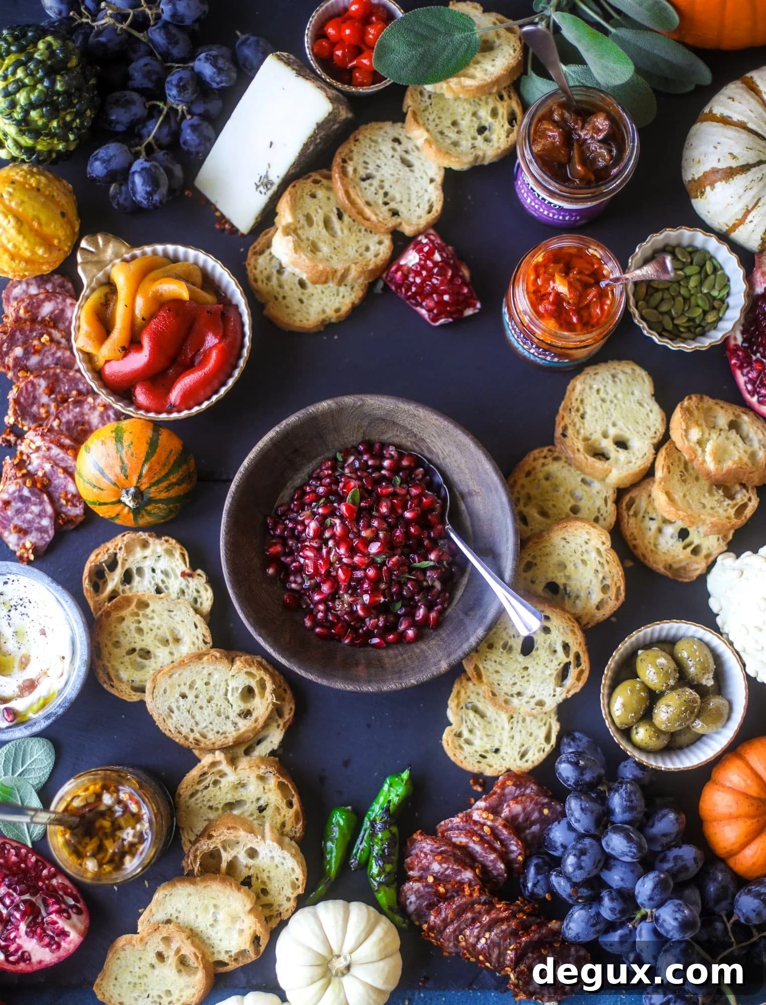Completed autumn bruschetta board with spreads, cheeses and fruit.
