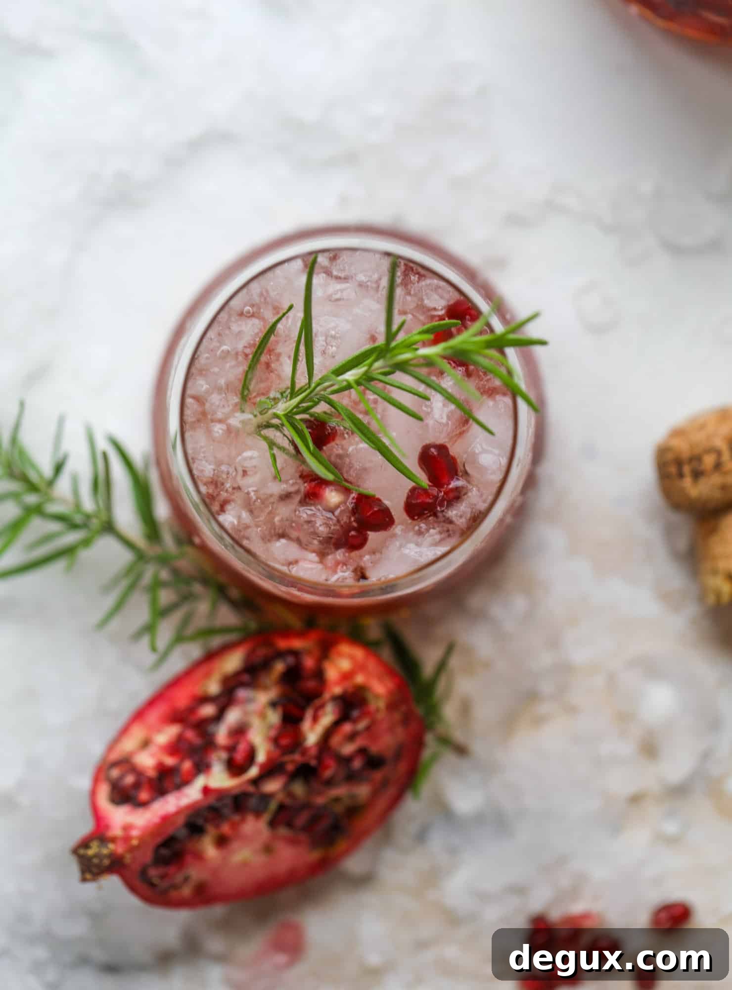 Pomegranate Prosecco Smash: 8 Thanksgiving Cocktails to Try 7 Two glasses of pomegranate prosecco smash with rosemary