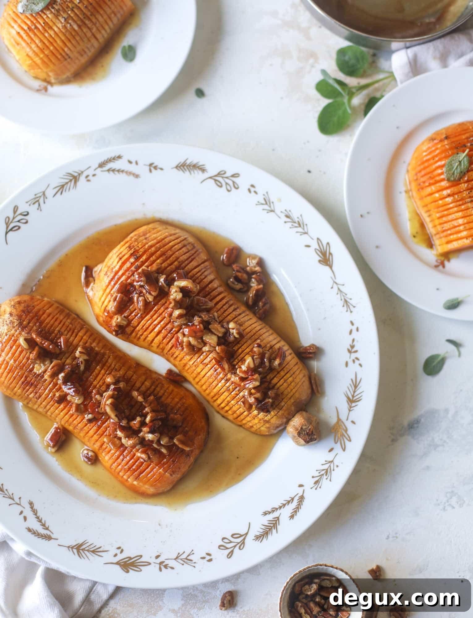 This hasselback butternut squash is perfect for Thanksgiving - and you can easily make it two ways! We have a maple pecan hasselback butternut squash and a brown butter sage hasselback butternut squash.