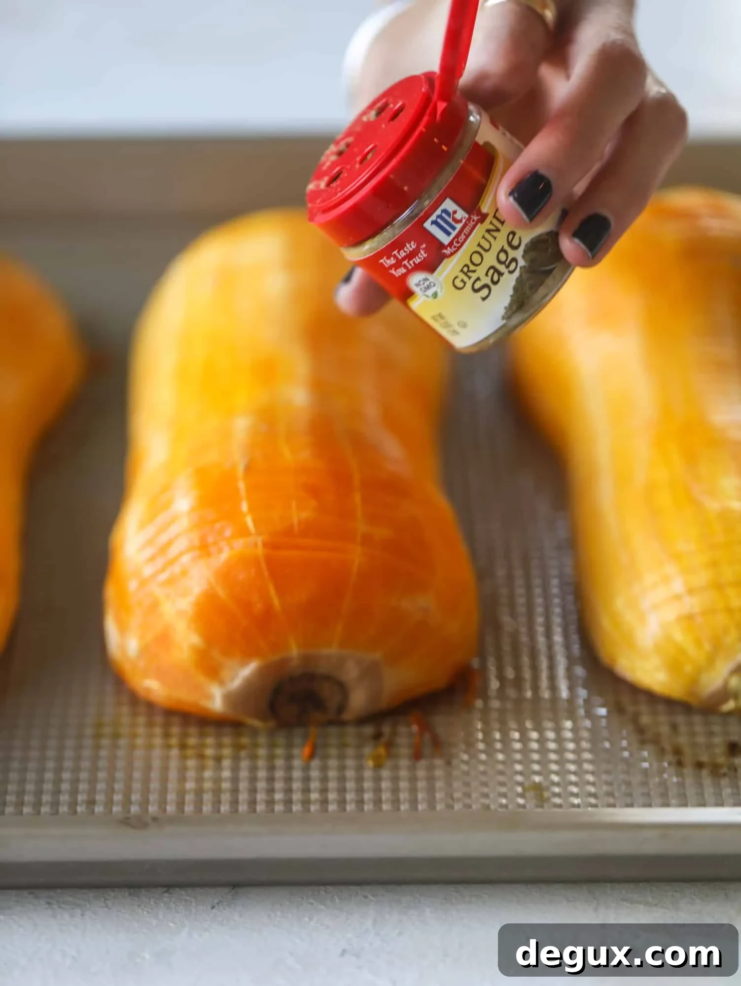 Close-up of hasselback butternut squash showing thin, even slices and glistening glaze.
