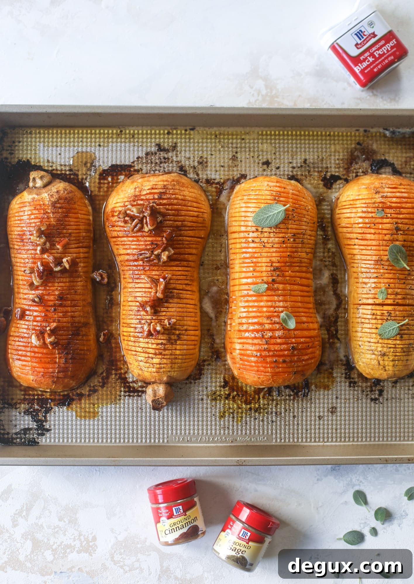 A serving platter of hasselback butternut squash with both maple pecan and brown butter sage varieties.