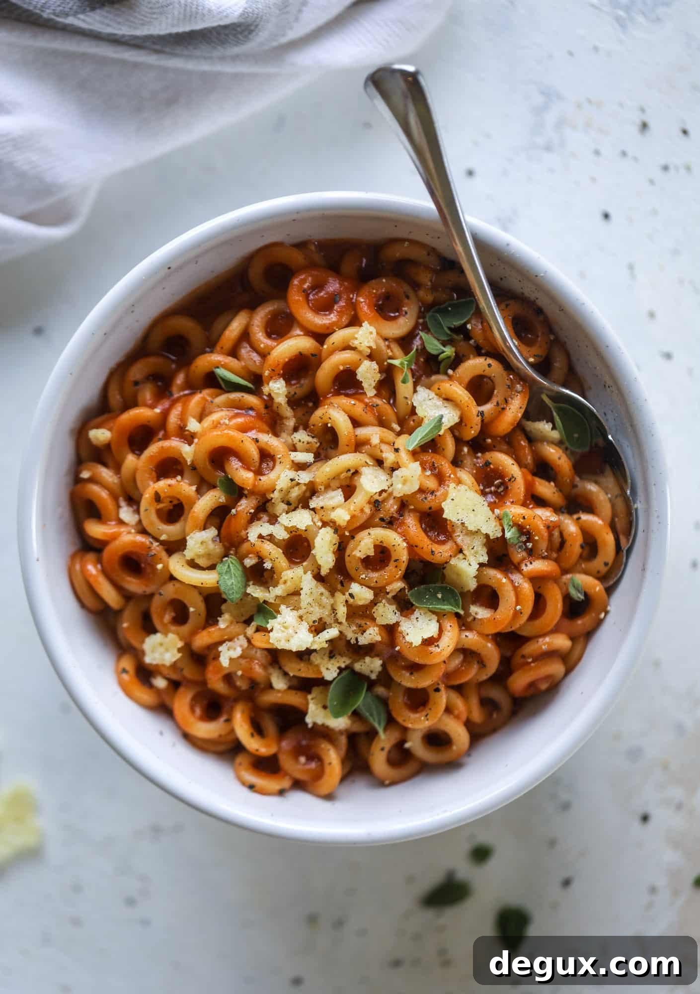 These homemade spaghettios are the ultimate comfort food! They come together in less than 30 minutes, are super easy and flavorful and topped with crispy crunchy manchego cheese that takes the taste over the top!
