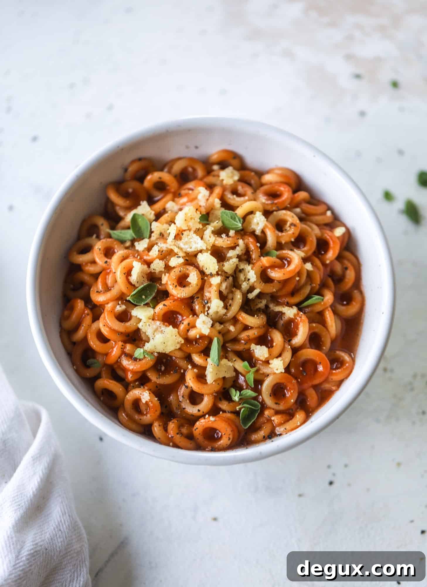 These homemade spaghettios are the ultimate comfort food! They come together in less than 30 minutes, are super easy and flavorful and topped with crispy crunchy manchego cheese that takes the taste over the top!