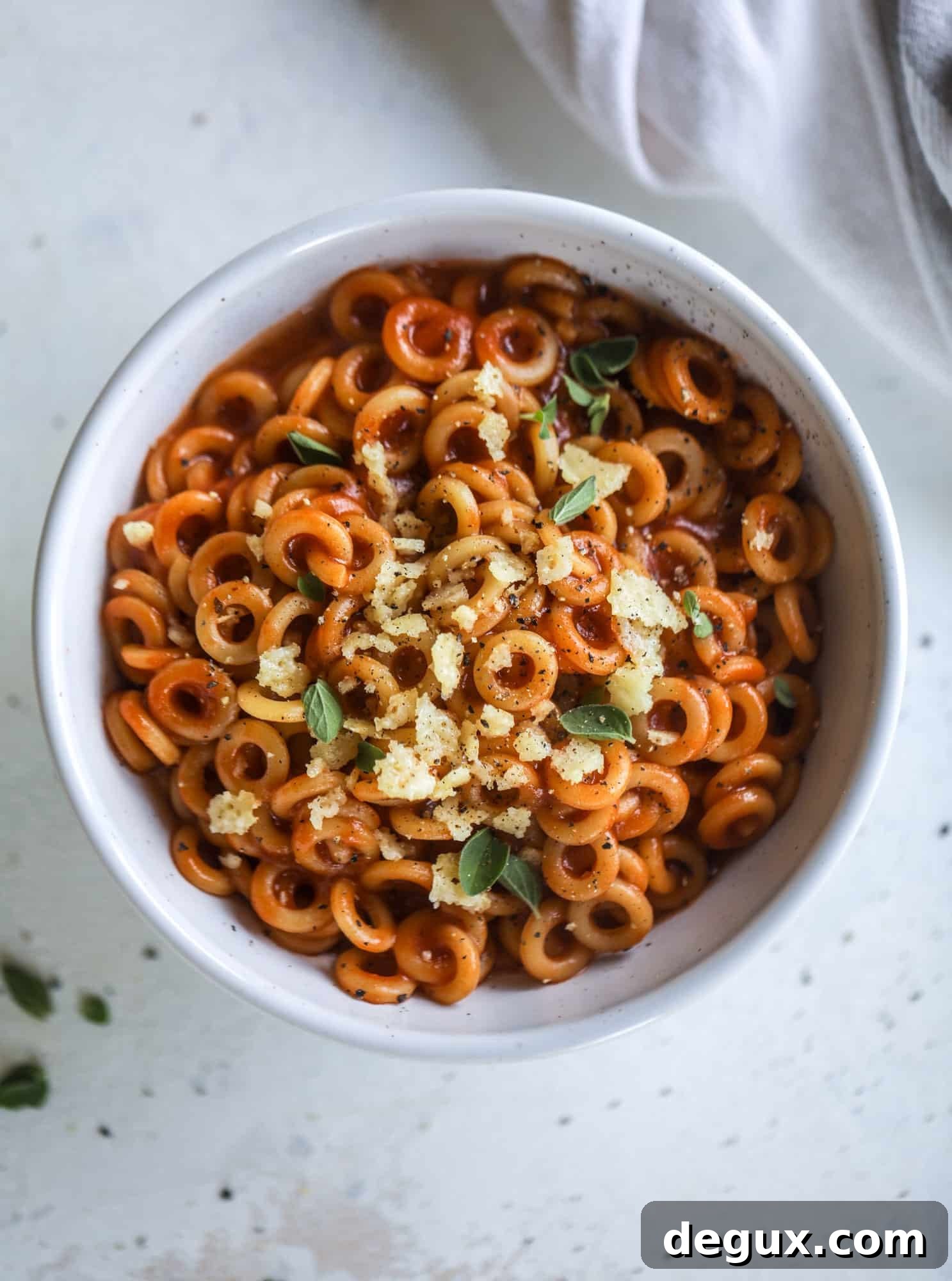These homemade spaghettios are the ultimate comfort food! They come together in less than 30 minutes, are super easy and flavorful and topped with crispy crunchy manchego cheese that takes the taste over the top!