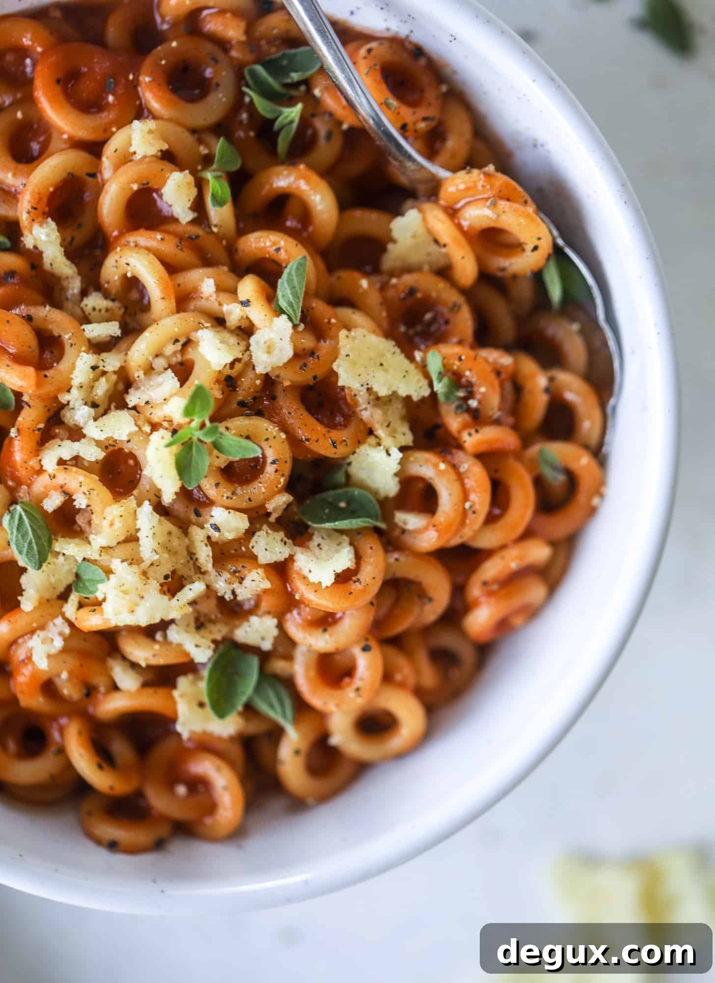 These homemade spaghettios are the ultimate comfort food! They come together in less than 30 minutes, are super easy and flavorful and topped with crispy crunchy manchego cheese that takes the taste over the top!