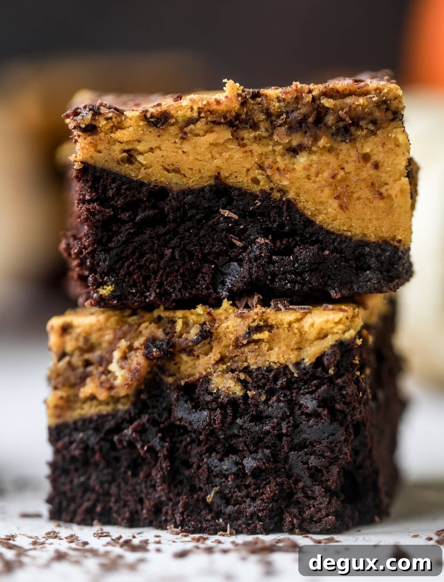 These pumpkin brownies have a fudgy layer of chocolate on the bottom and a silky layer of pumpkin on top! They are so delicious and rich and perfect for fall. The pumpkin brownies come together easily and can be made ahead of time too!